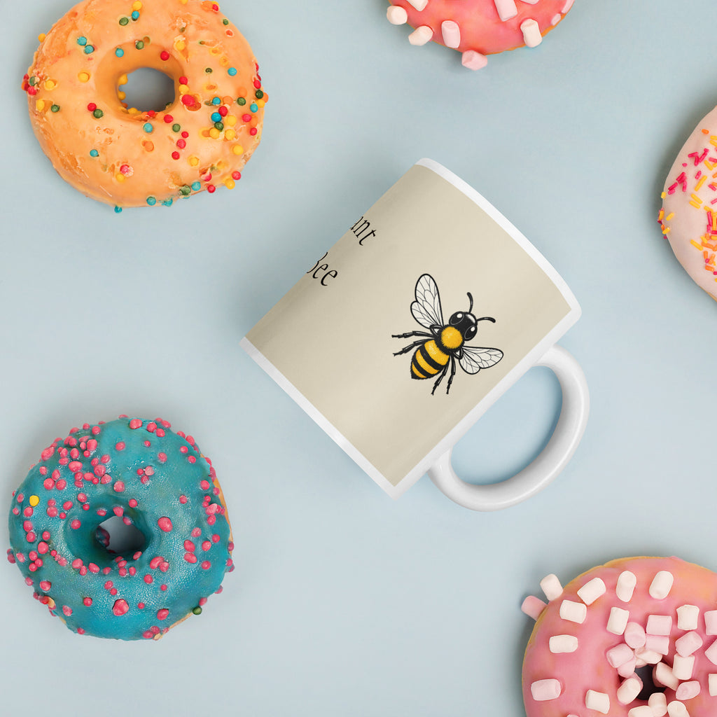Light beige ceramic mug with bee graphic and partial “Meant to Bee” text