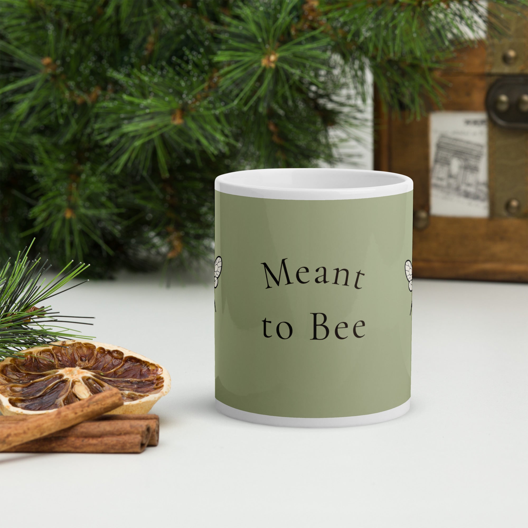 Sage green ceramic mug with 'Meant to Bee' text on front and white handle