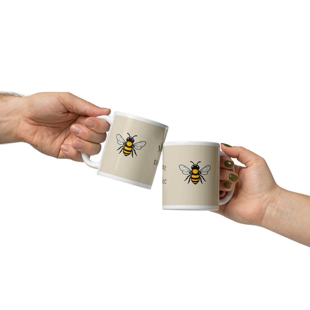 Light beige ceramic coffee mug with bee illustration on front