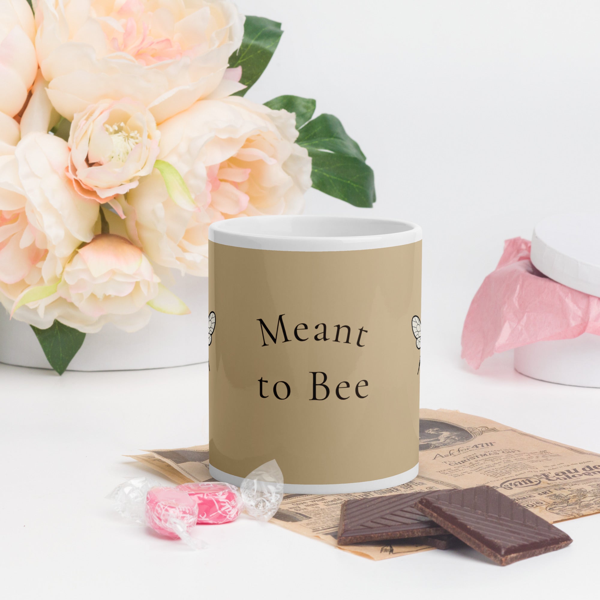 Beige ceramic coffee mug with 'Meant to Bee' text and white handle