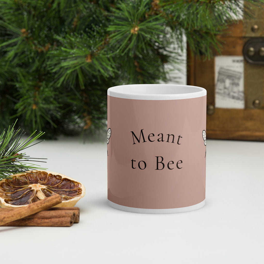 Dusty rose ceramic mug with 'Meant to Bee' lettering and white handle.