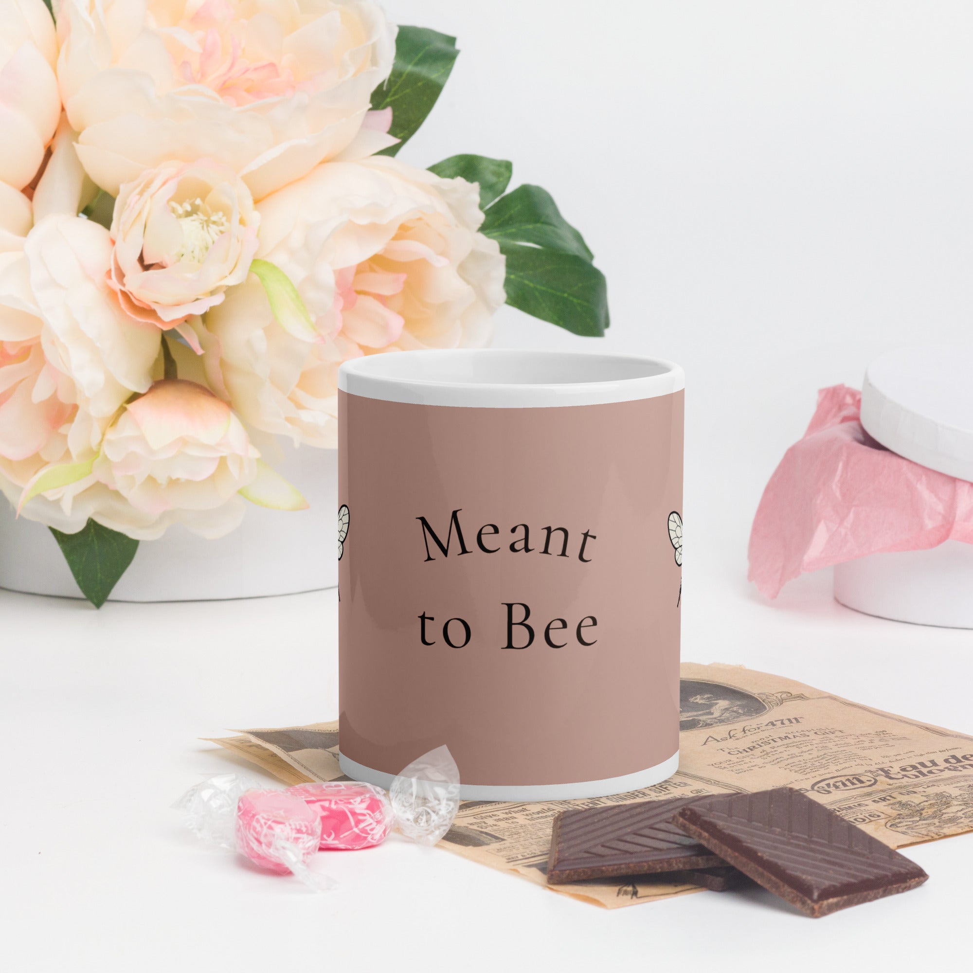 Dusty rose ceramic coffee mug with “Meant to Bee” lettering on front.