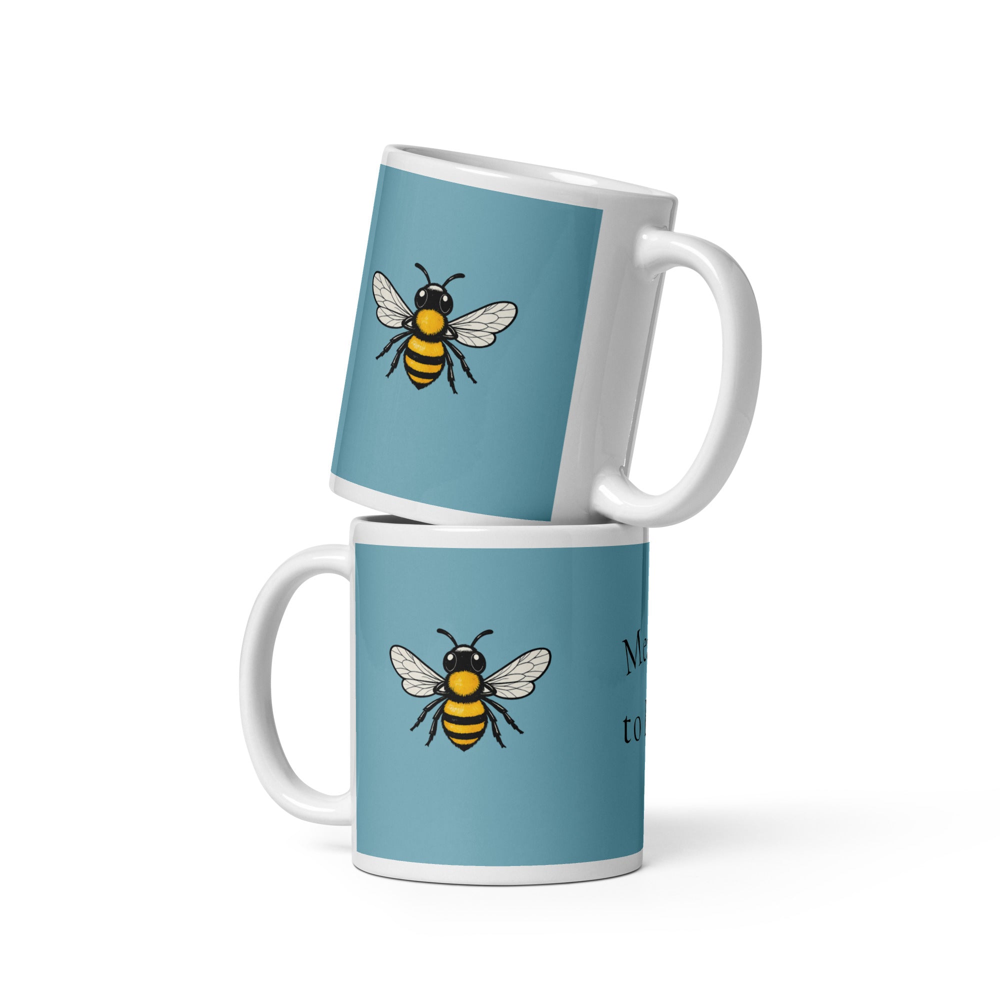 Blue ceramic coffee mug with bee illustration, white handle