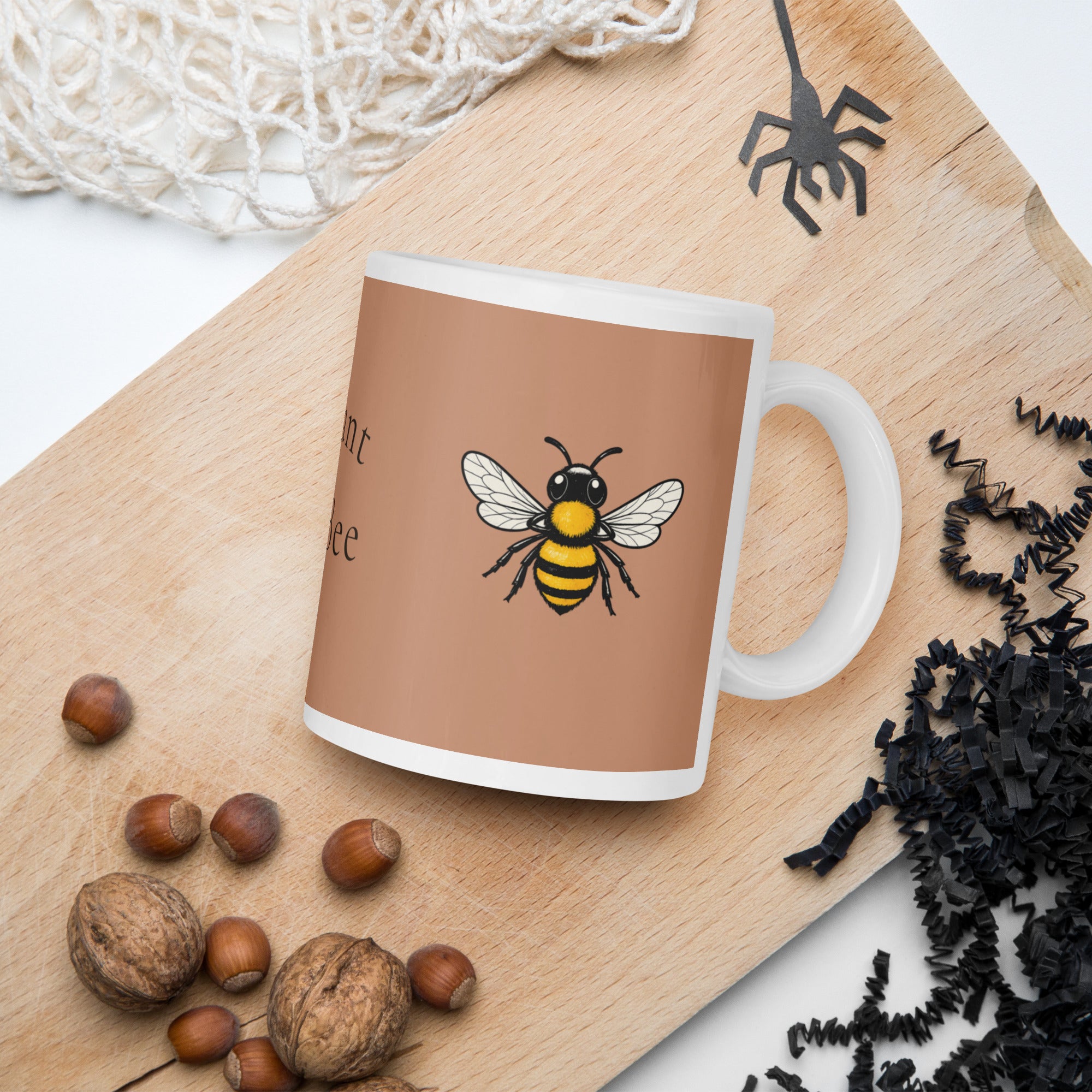 Brown ceramic mug with bee illustration; close angle with handle visible