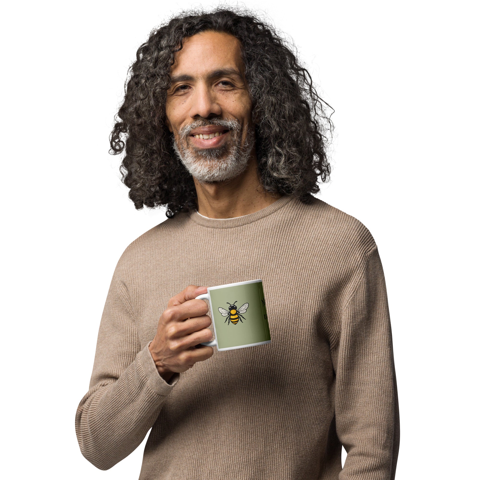 Sage green ceramic coffee mug with bee illustration, held at chest height