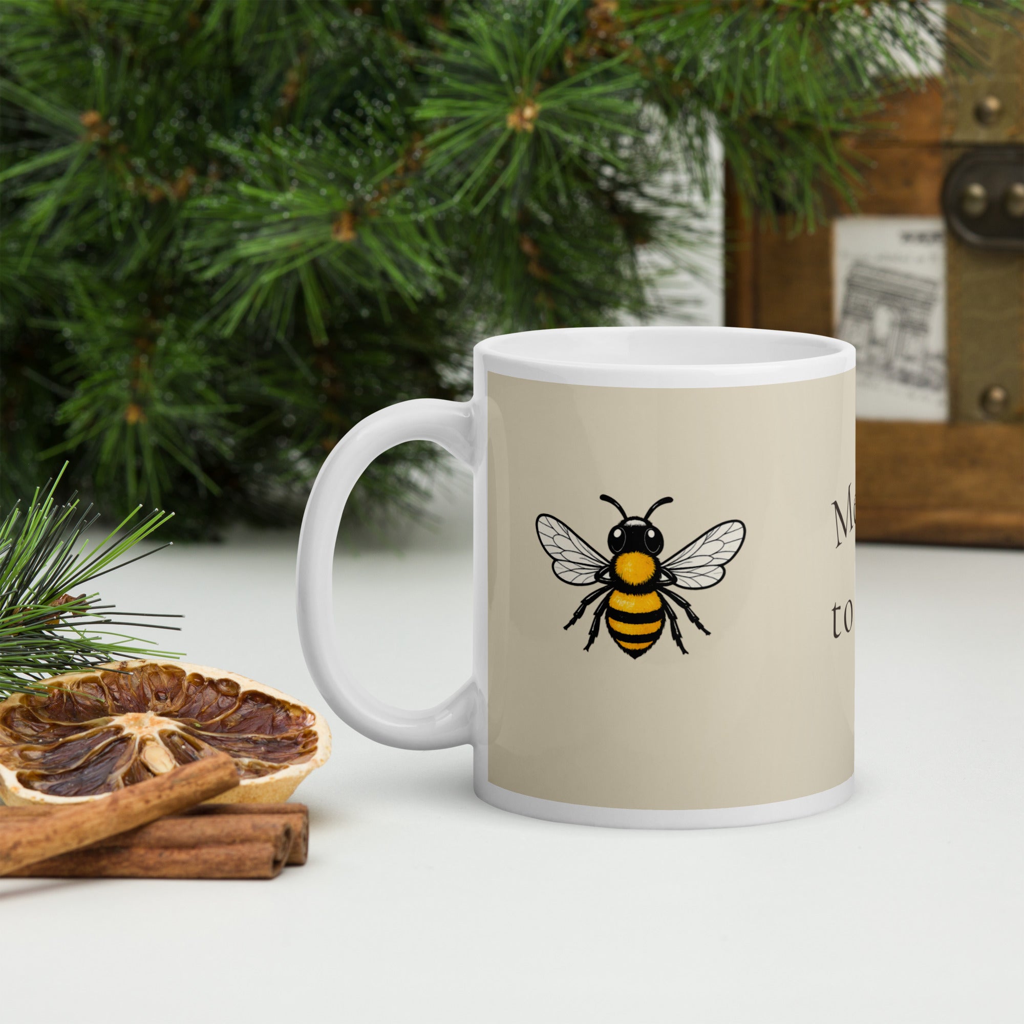 Light beige ceramic mug with centered bee illustration and white handle