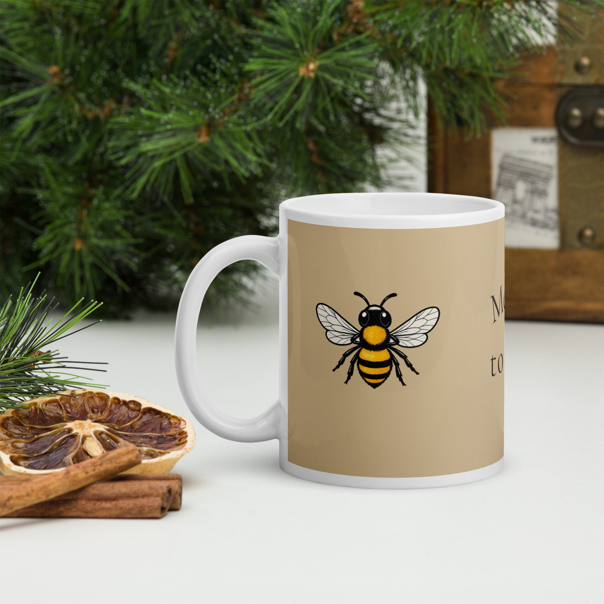 Beige ceramic coffee mug with bee illustration, front view and white handle