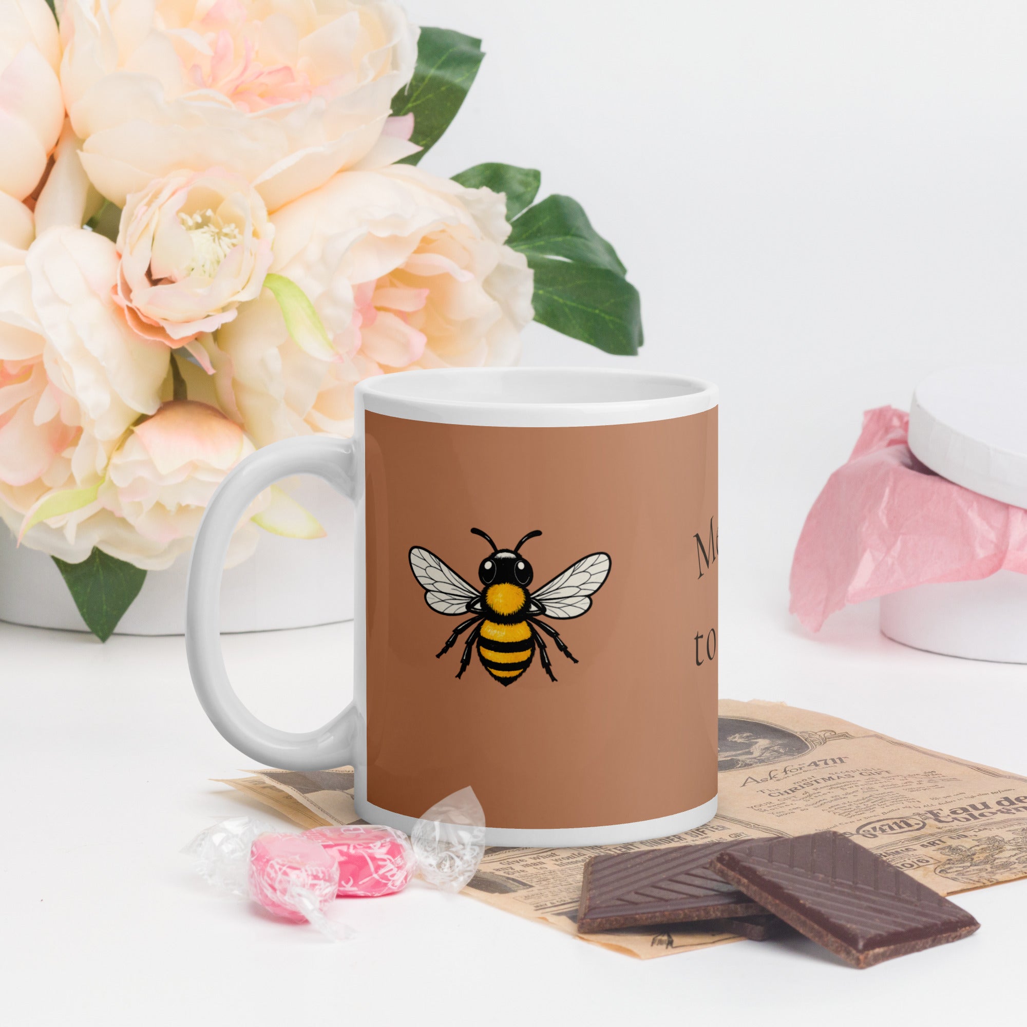 Brown ceramic mug with bee illustration and white handle
