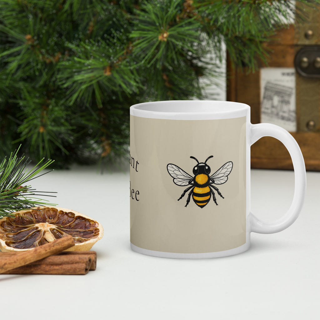Light beige ceramic mug with bee illustration and partial text on side