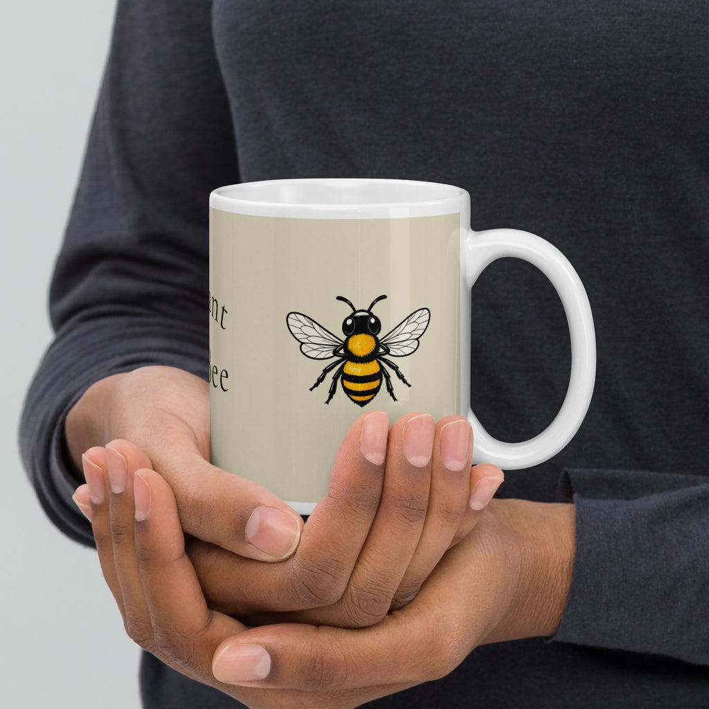 Light beige ceramic mug with bee illustration and white handle