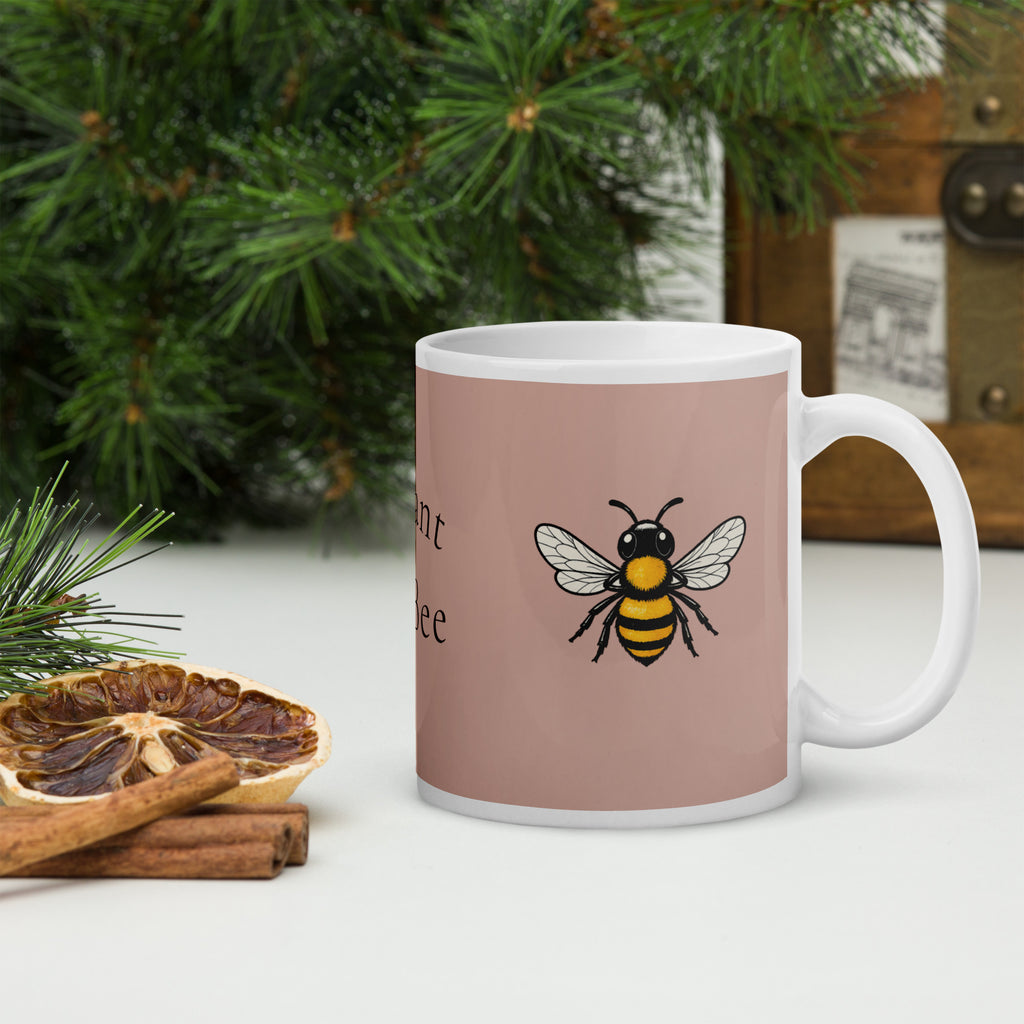 Dusty rose ceramic mug with white handle and bee illustration; black and yellow bee.