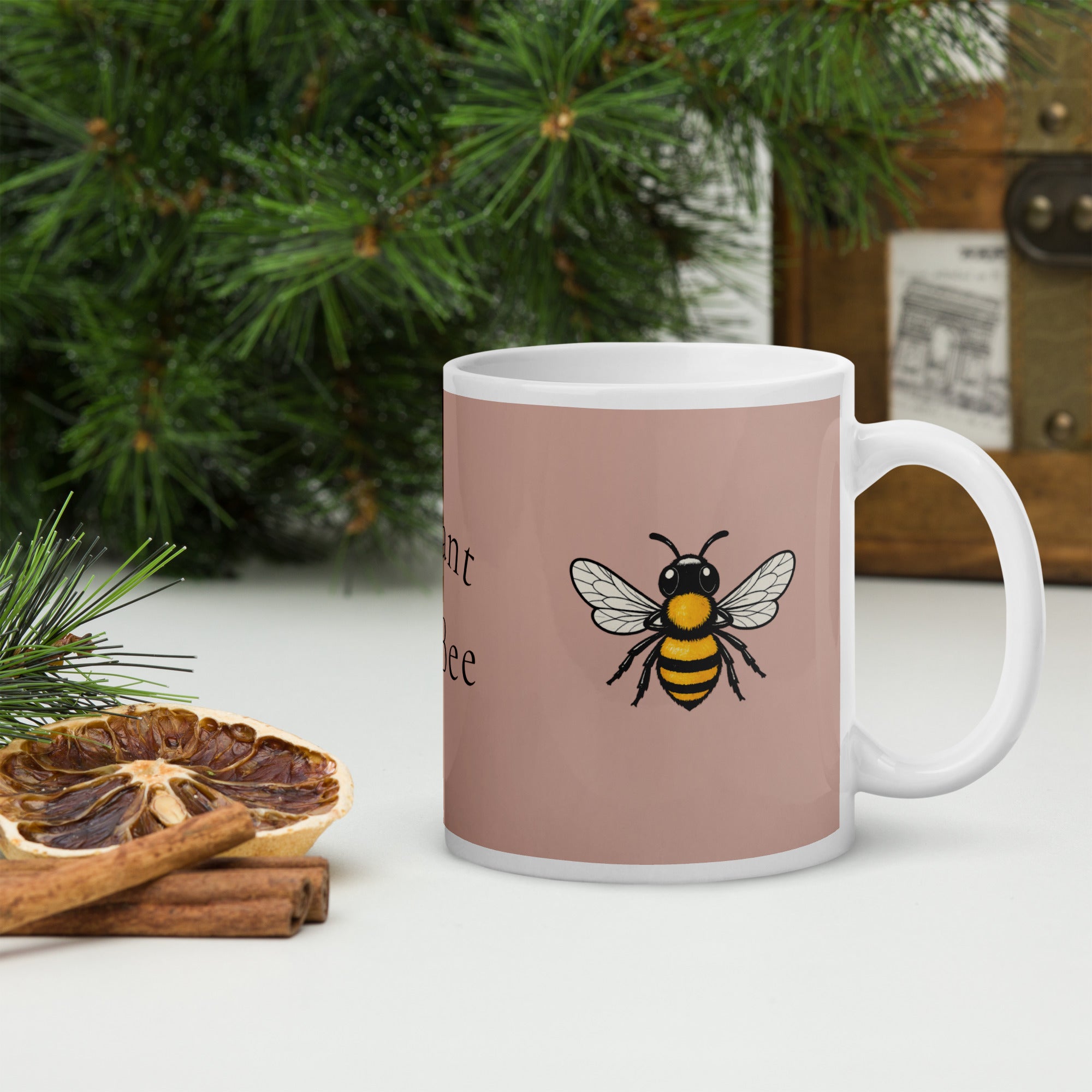 Dusty rose ceramic mug with white handle and bee illustration; black and yellow bee.