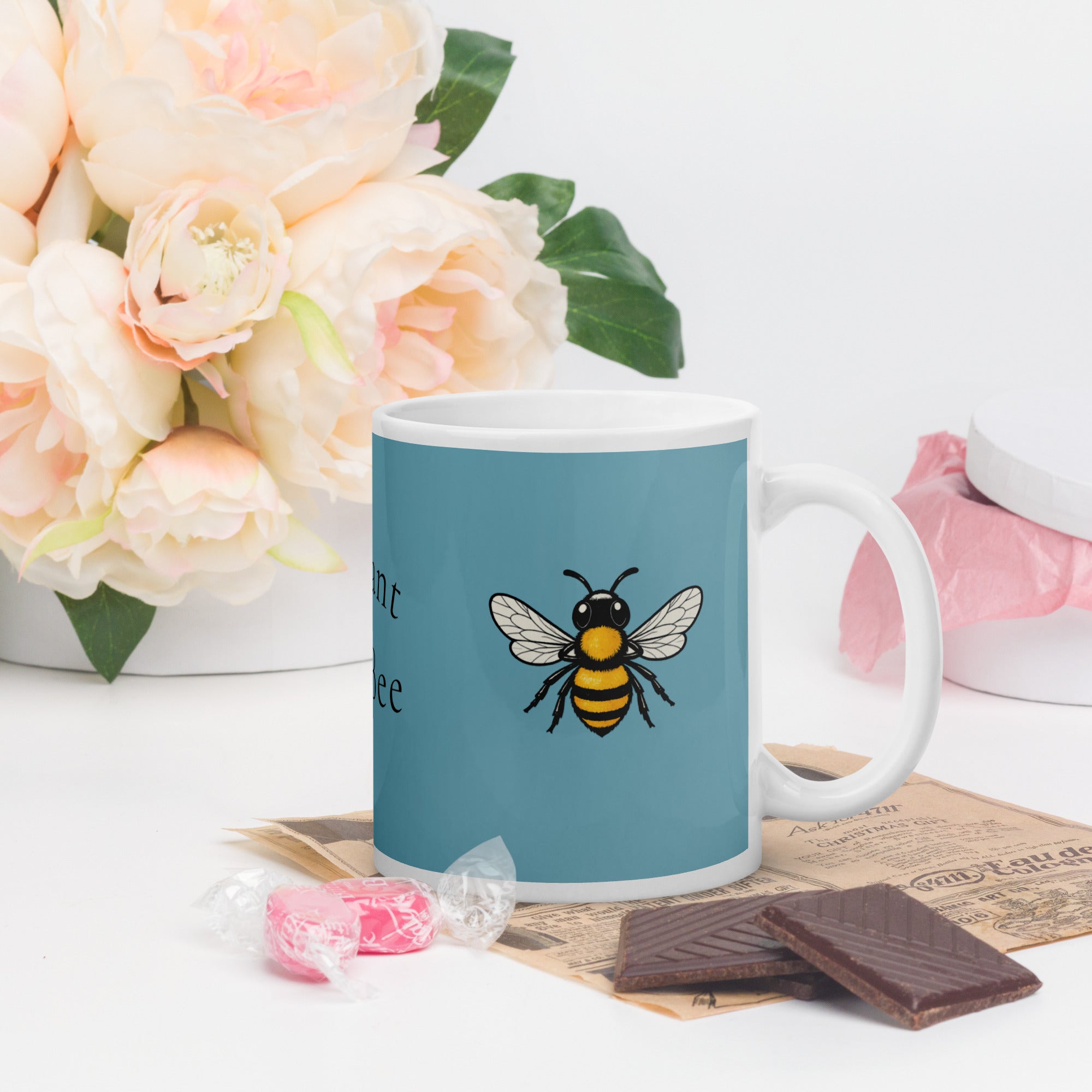Blue ceramic coffee mug with black and yellow bee illustration on front
