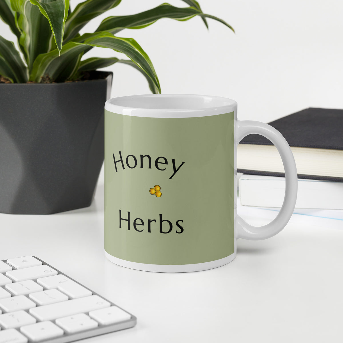 Green ceramic mug with “Honey Herbs” text and bee icon, white handle visible.