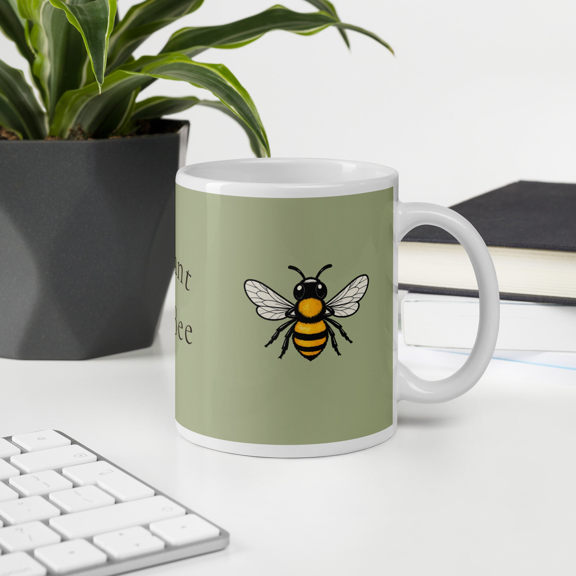 Sage green ceramic coffee mug featuring a centered bee illustration