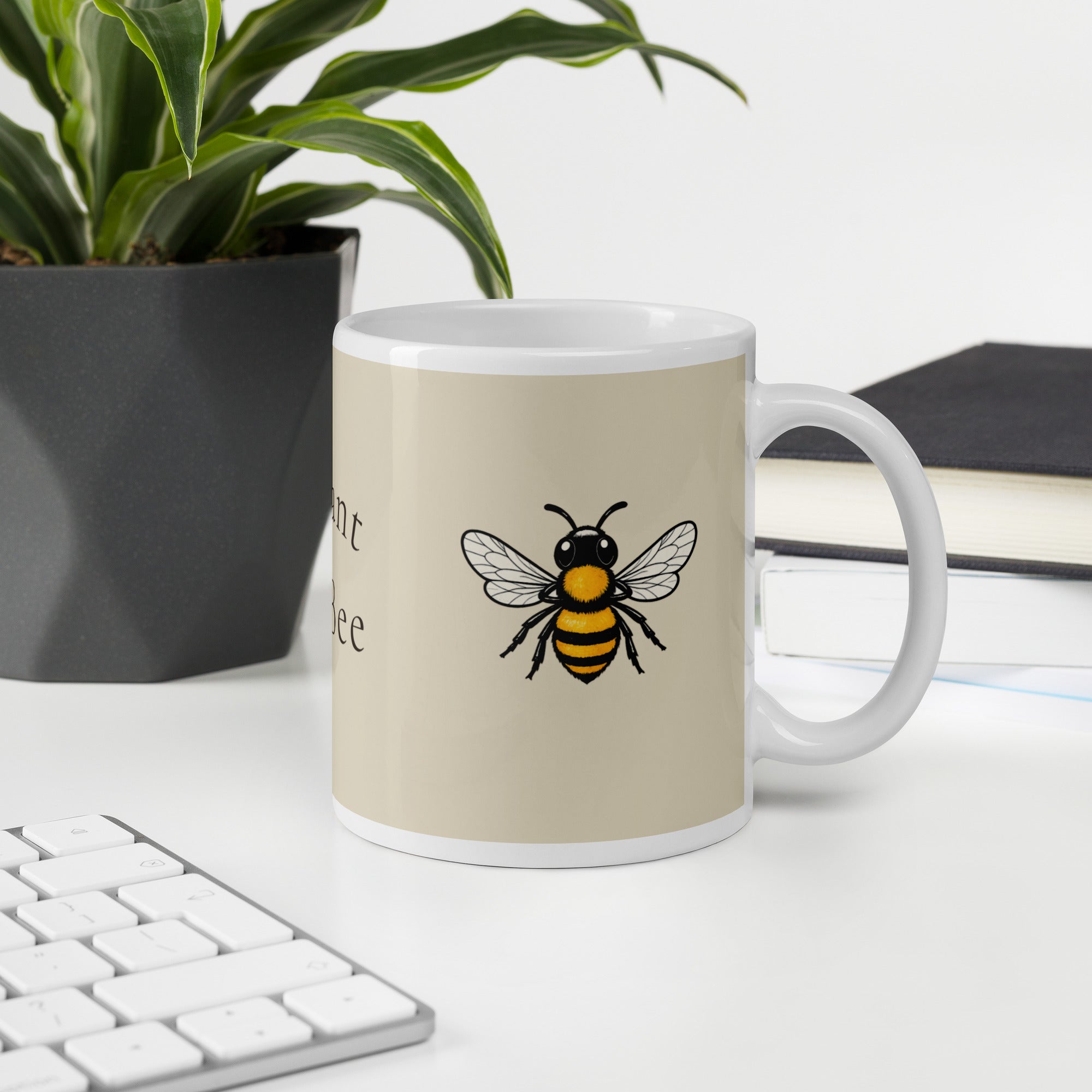 Light beige ceramic coffee mug with centered bee graphic and white handle