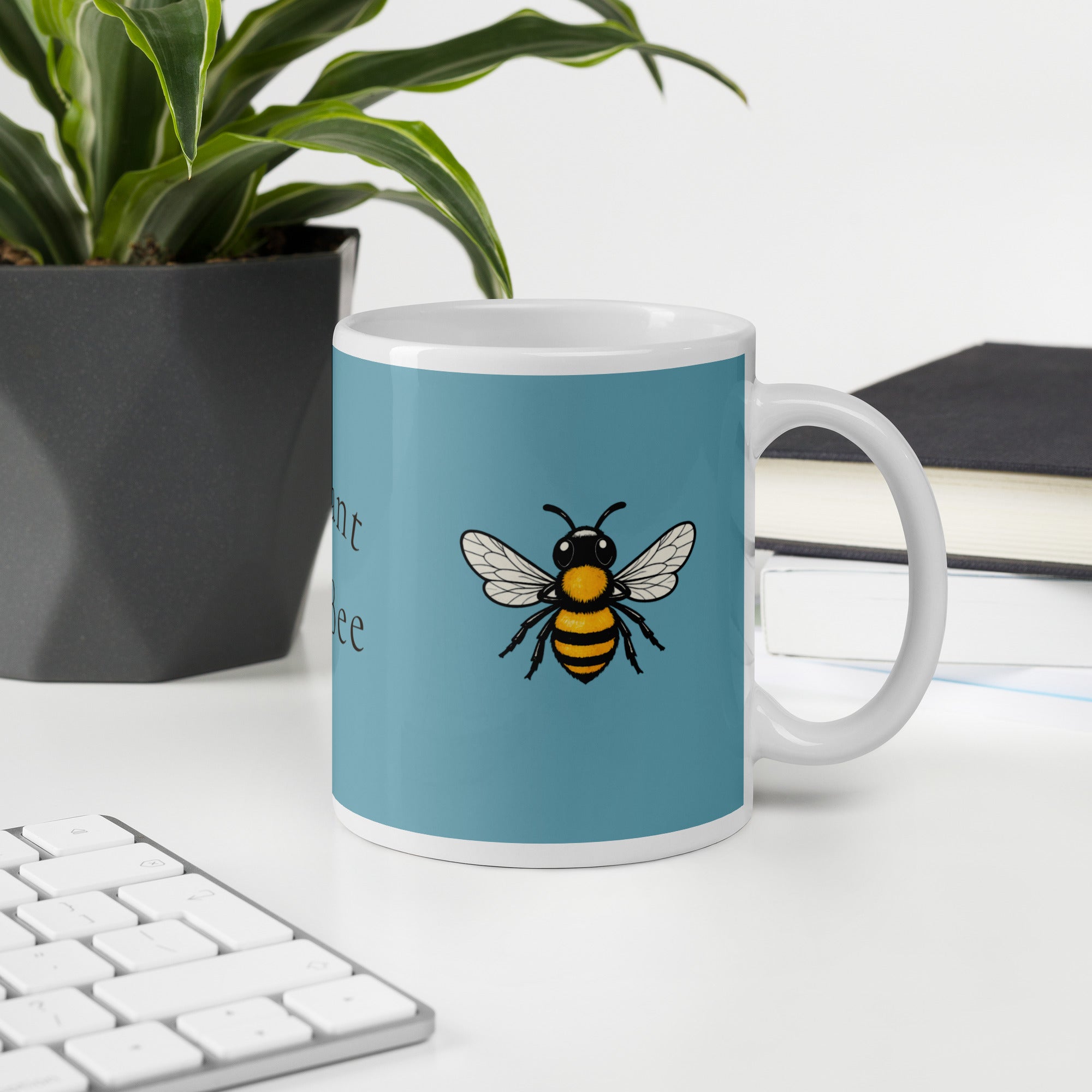 Blue ceramic coffee mug with bee illustration, side view, white handle and rim.