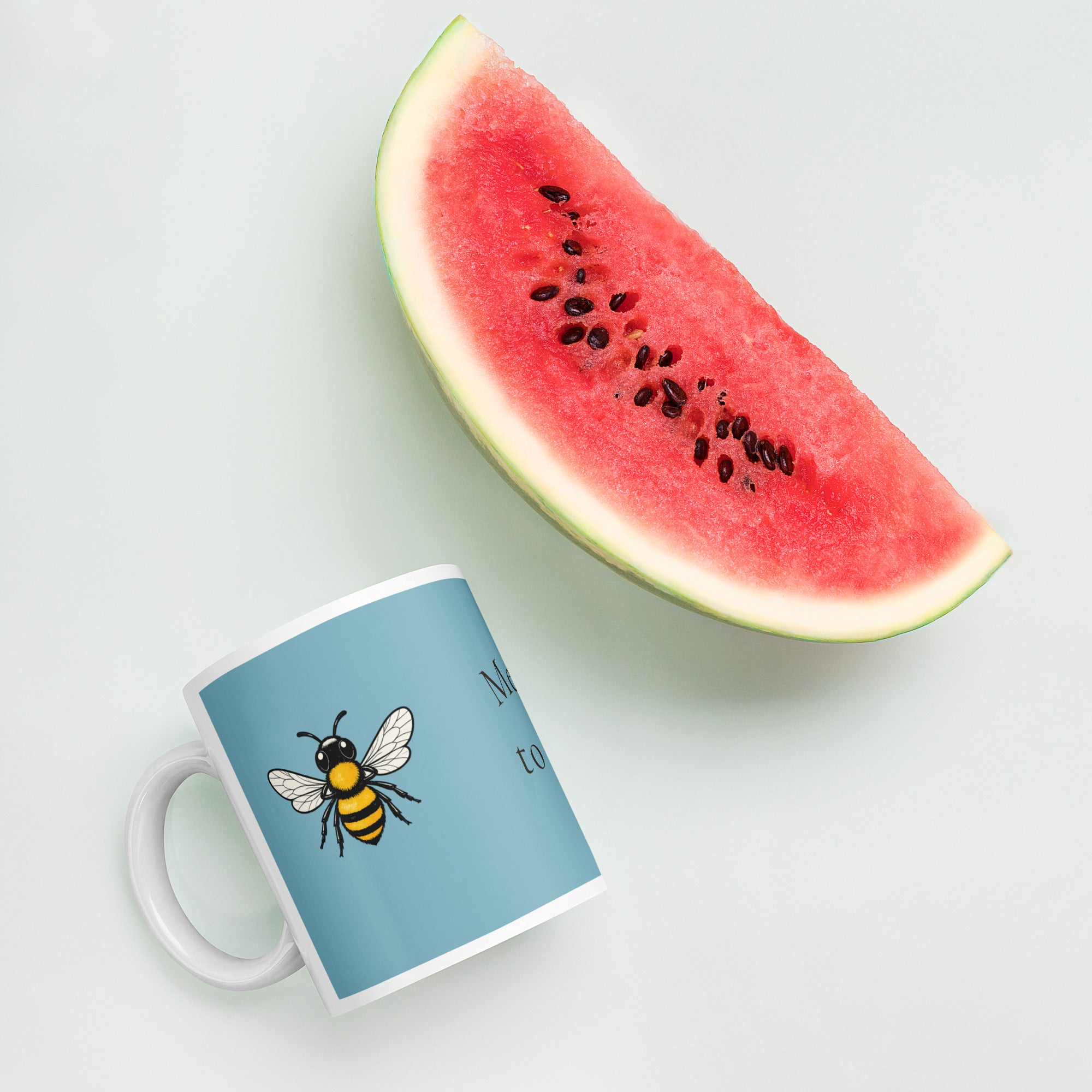 Blue ceramic mug with bee illustration and white handle