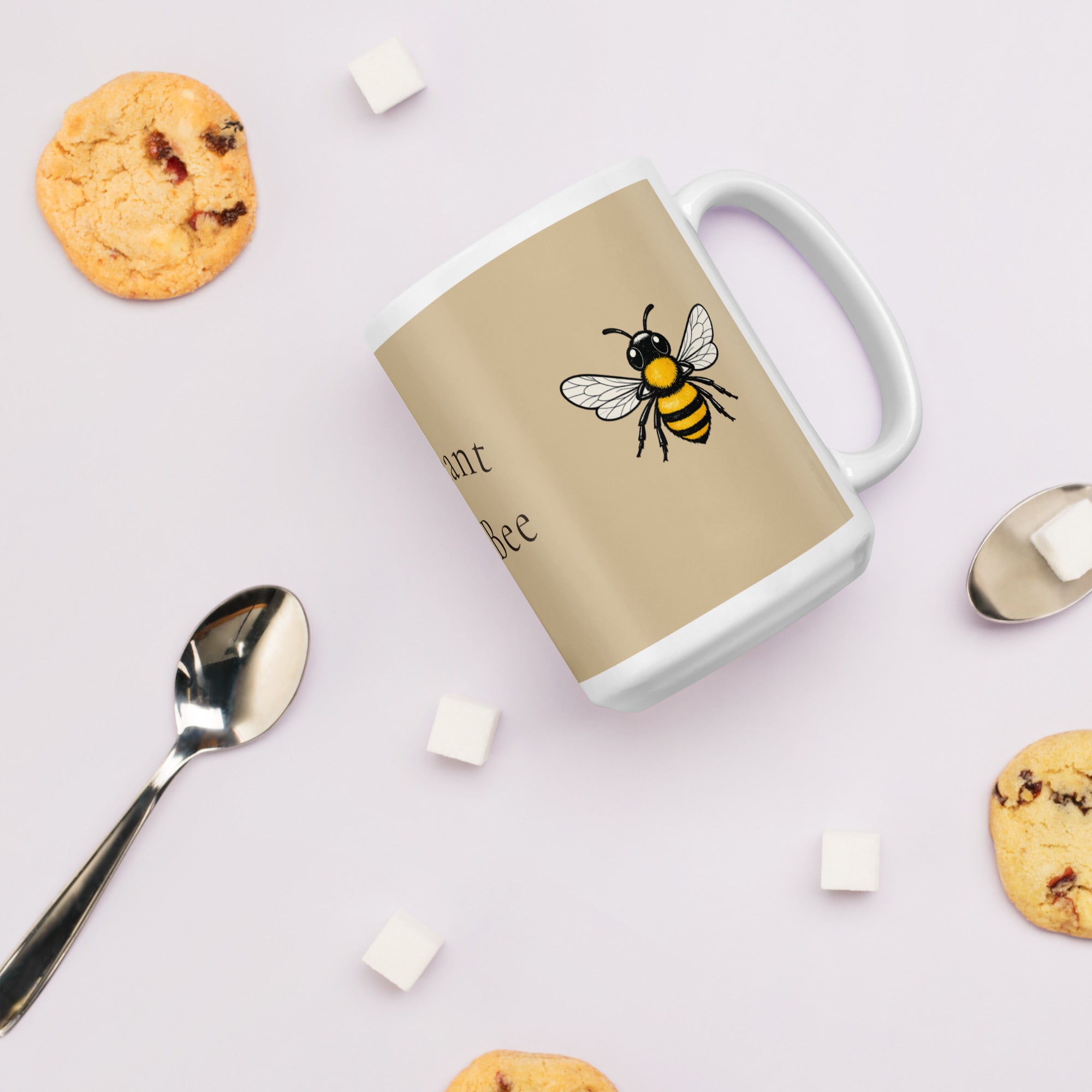 Beige ceramic mug with bee illustration on side panel, white handle