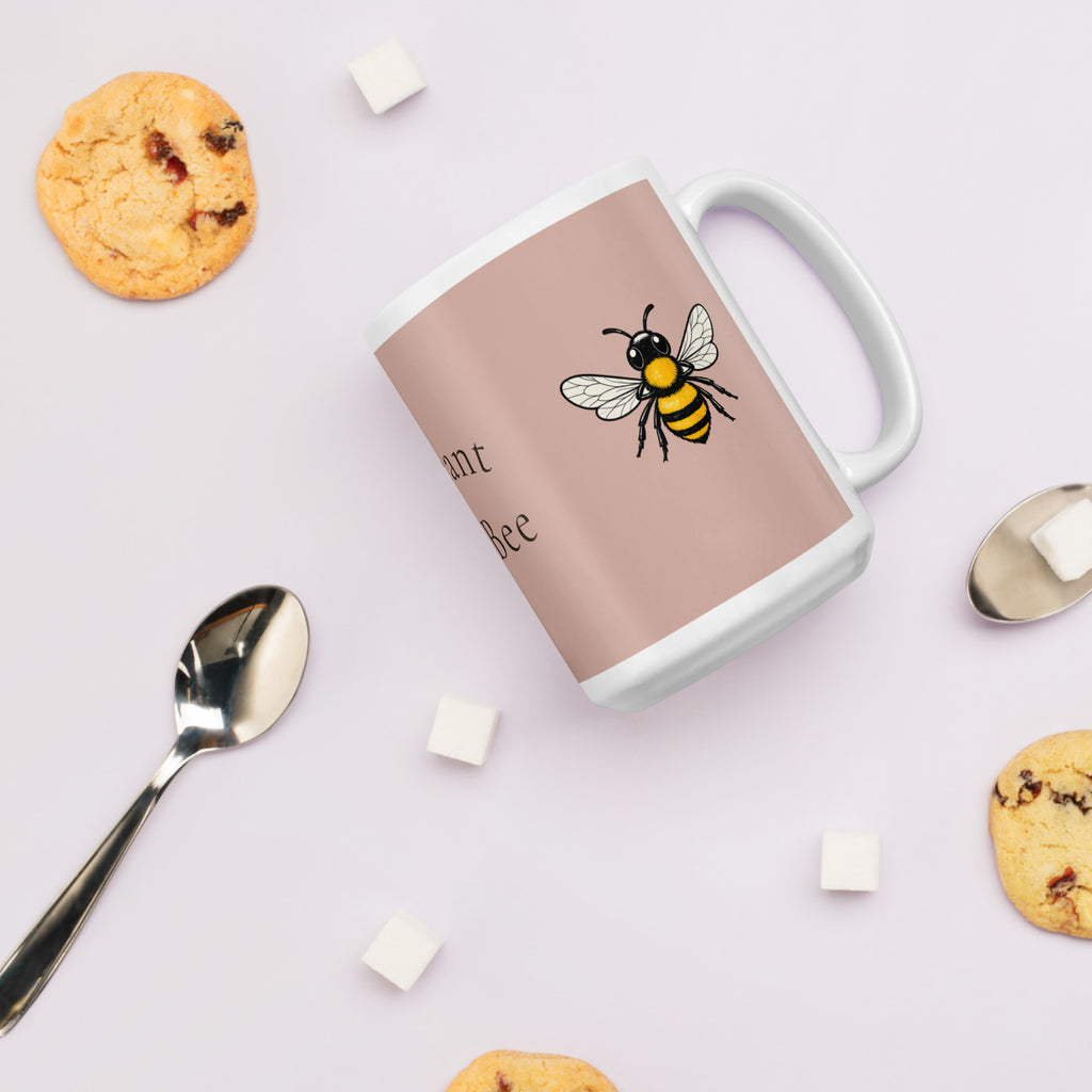 Dusty rose ceramic mug with bee illustration; white handle and thick white base.