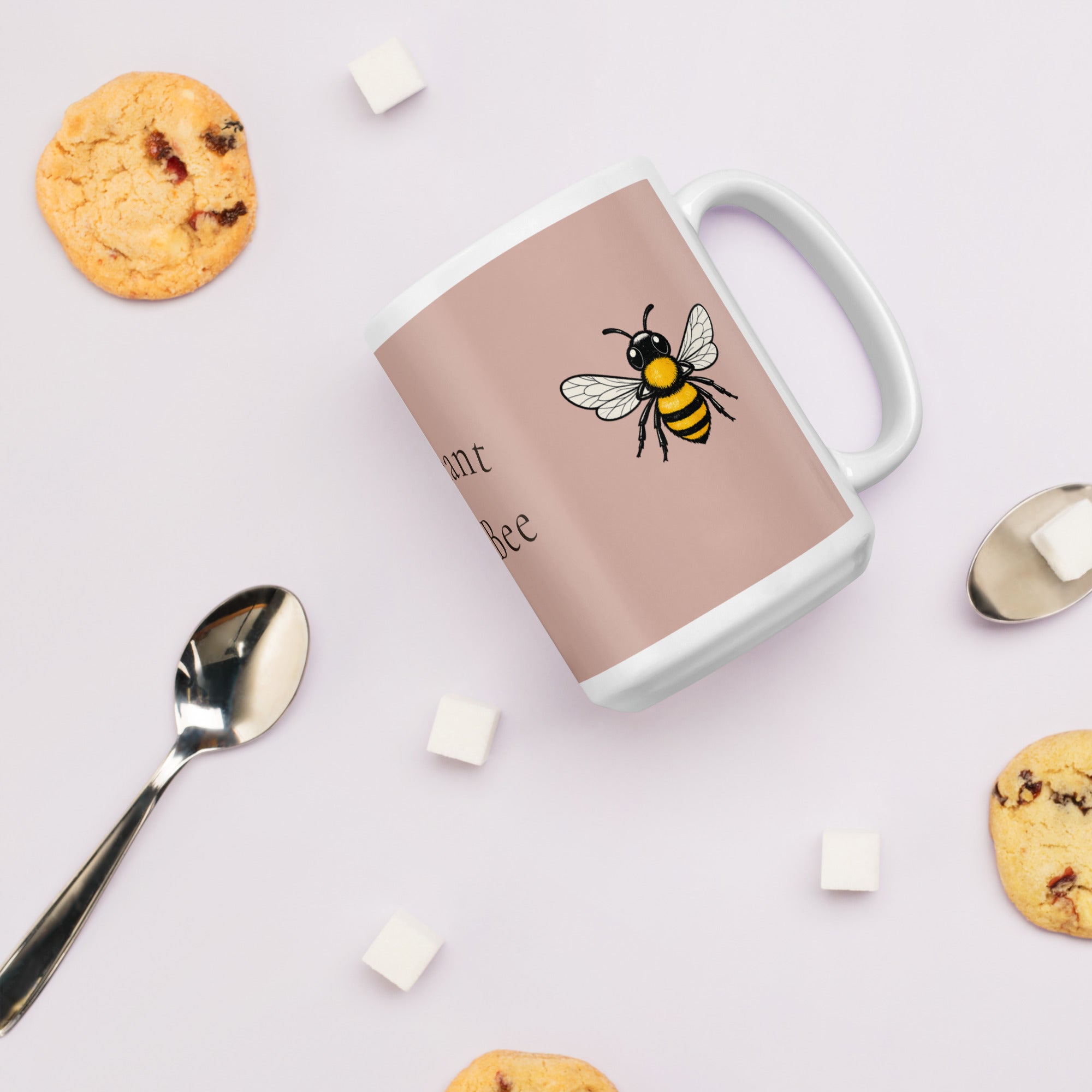 Dusty rose ceramic mug with bee illustration; white handle and thick white base.