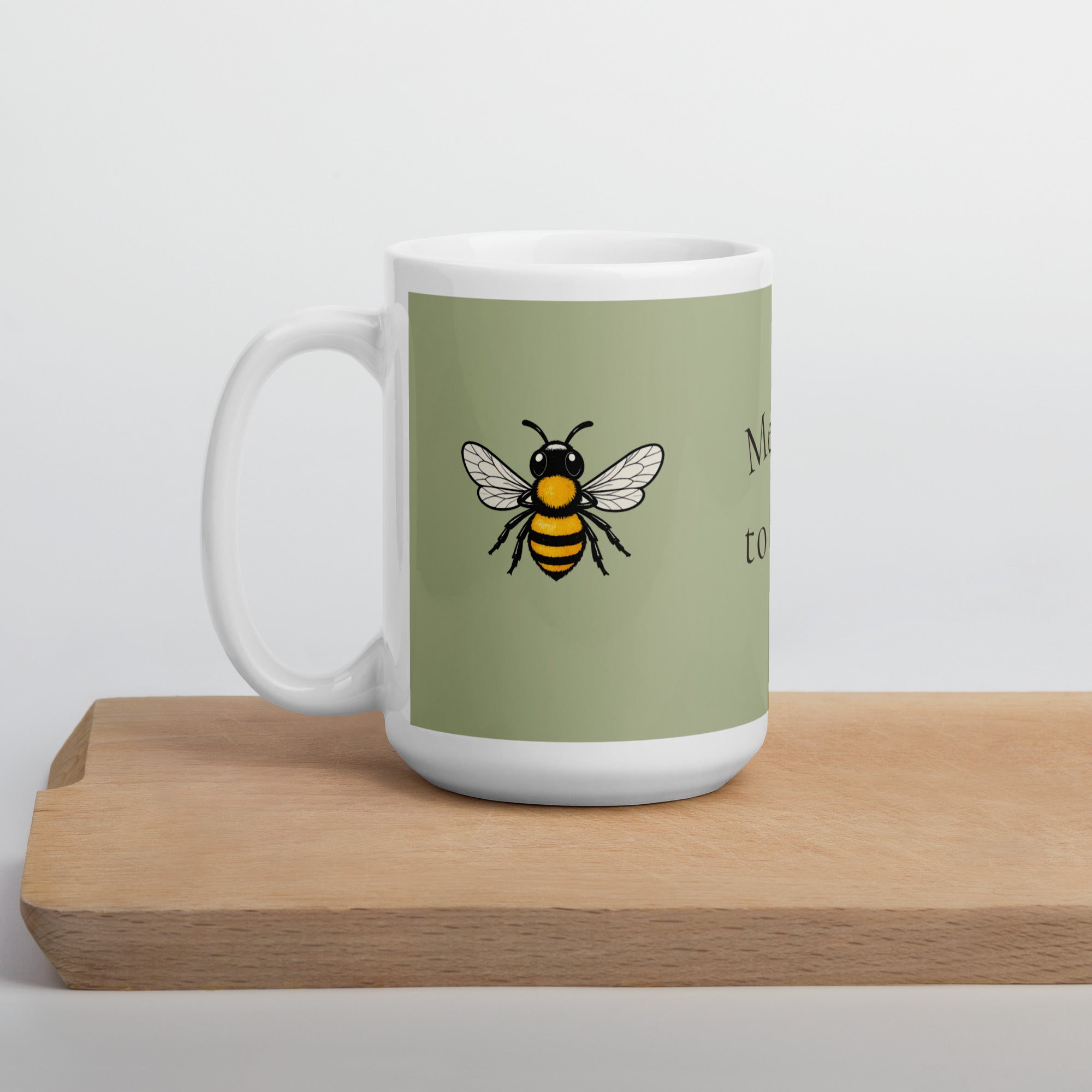 Sage green ceramic coffee mug with bee illustration, full front view
