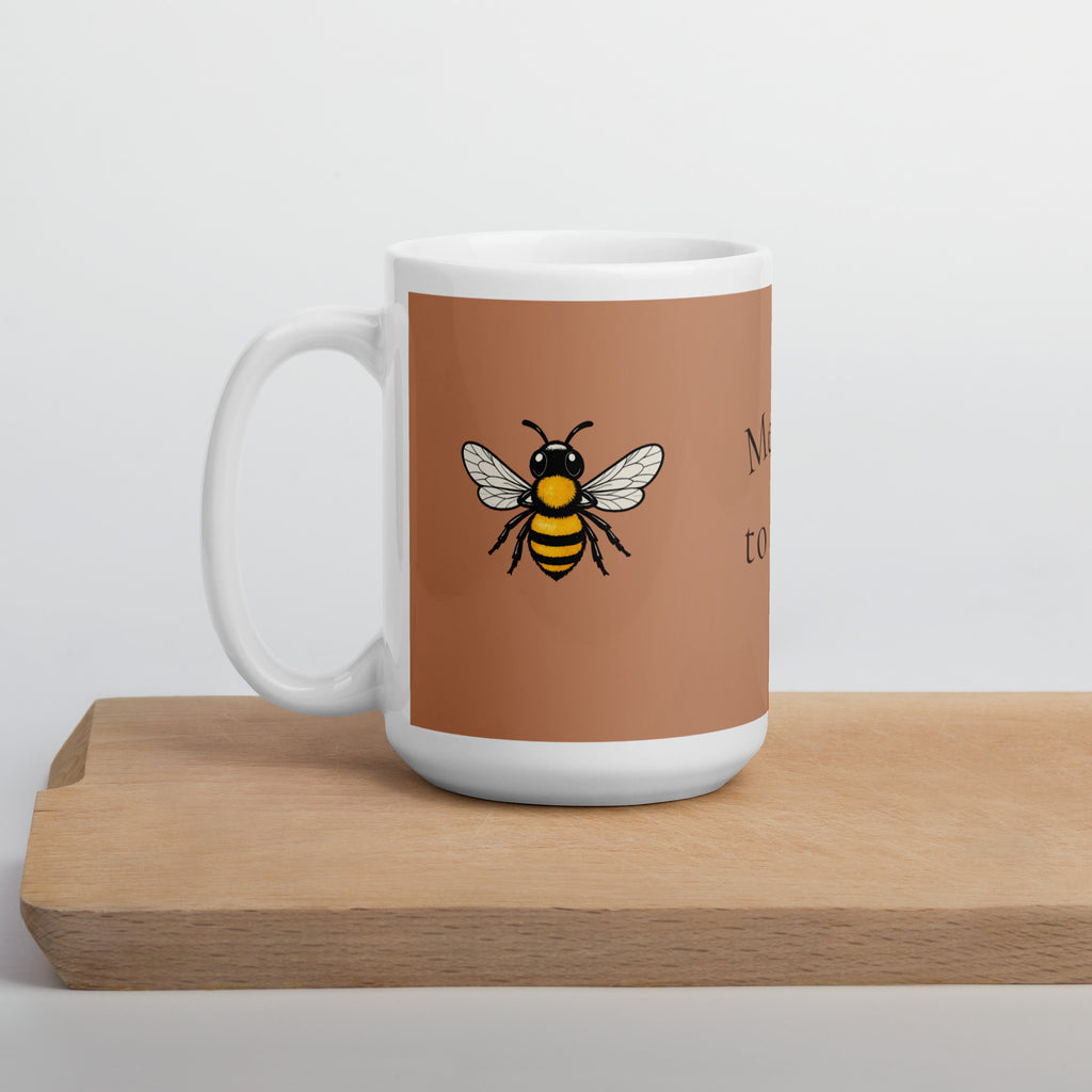 Brown ceramic coffee mug with bee illustration on a wooden base, studio view