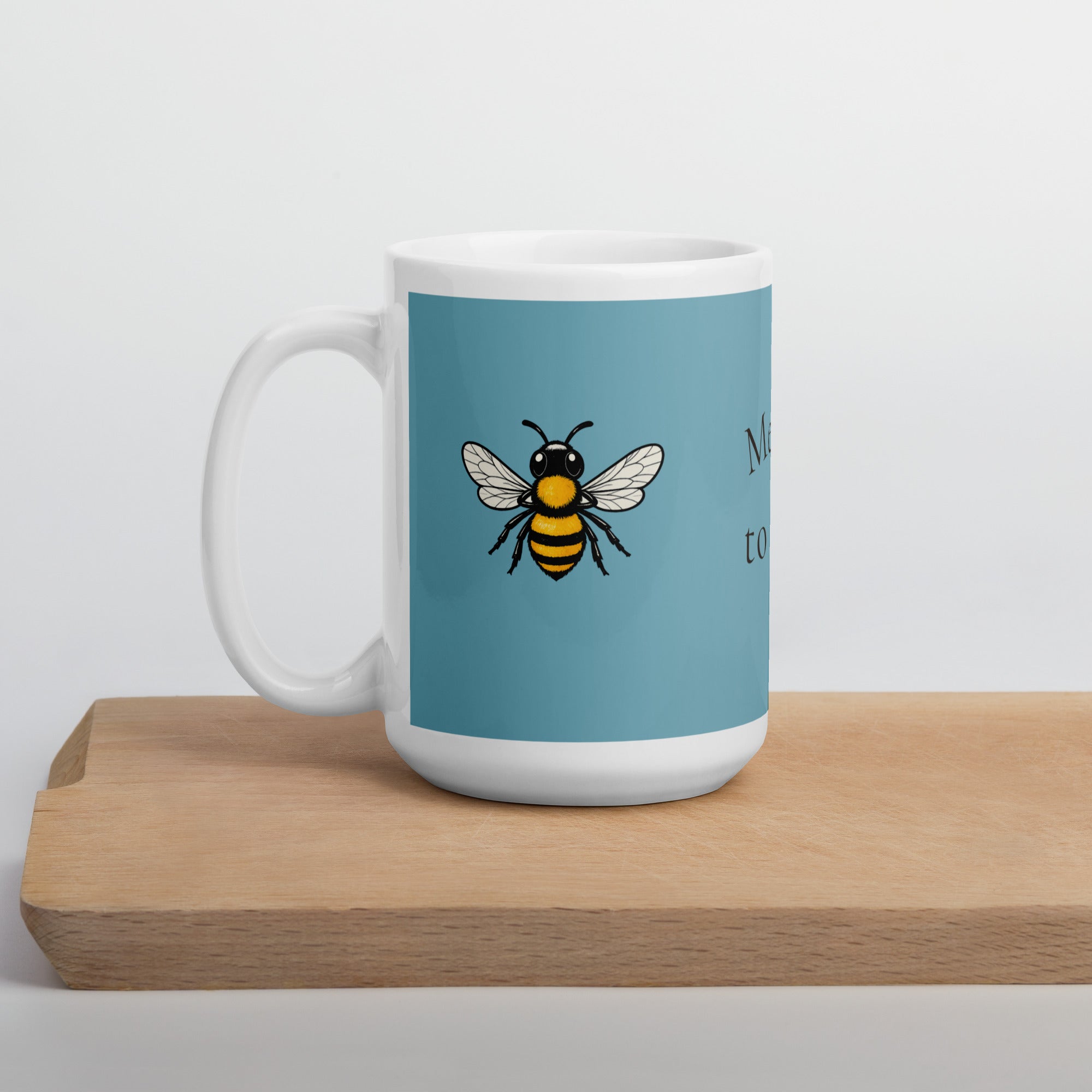 Blue ceramic coffee mug with bee illustration, white handle