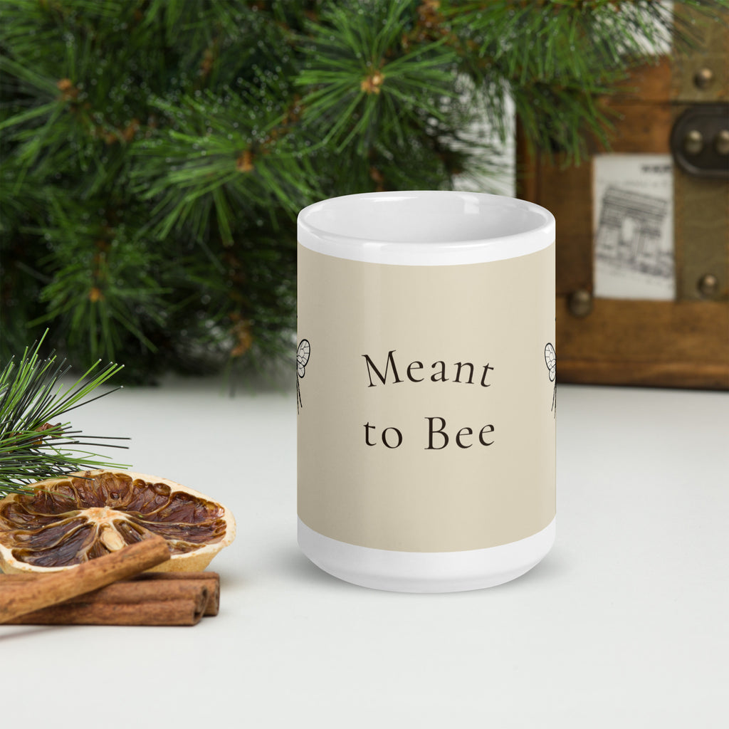 Light beige ceramic mug with 'Meant to Bee' text on front and white handle