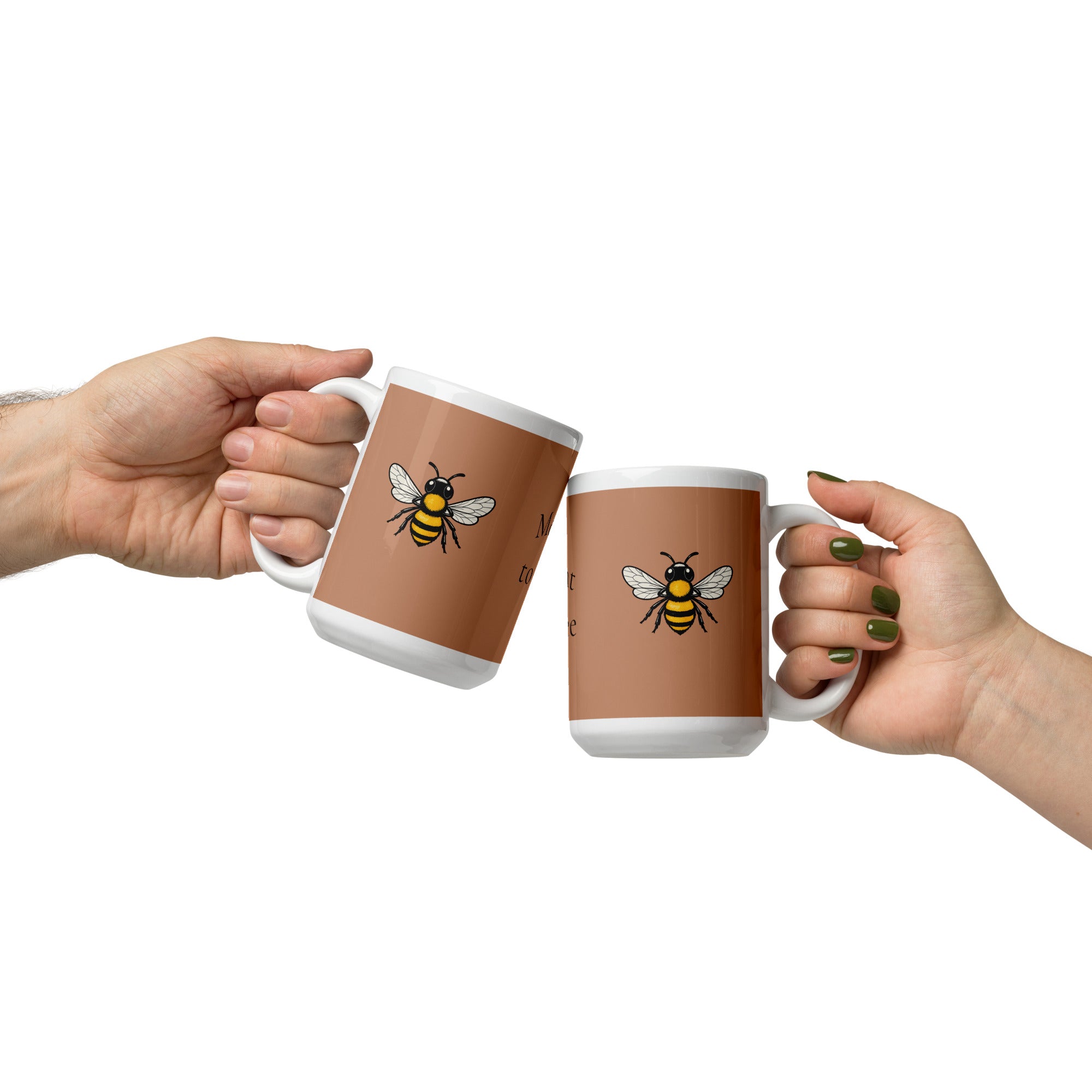 Two white and brown ceramic mugs with bee illustrations, clutched in hands facing each other.