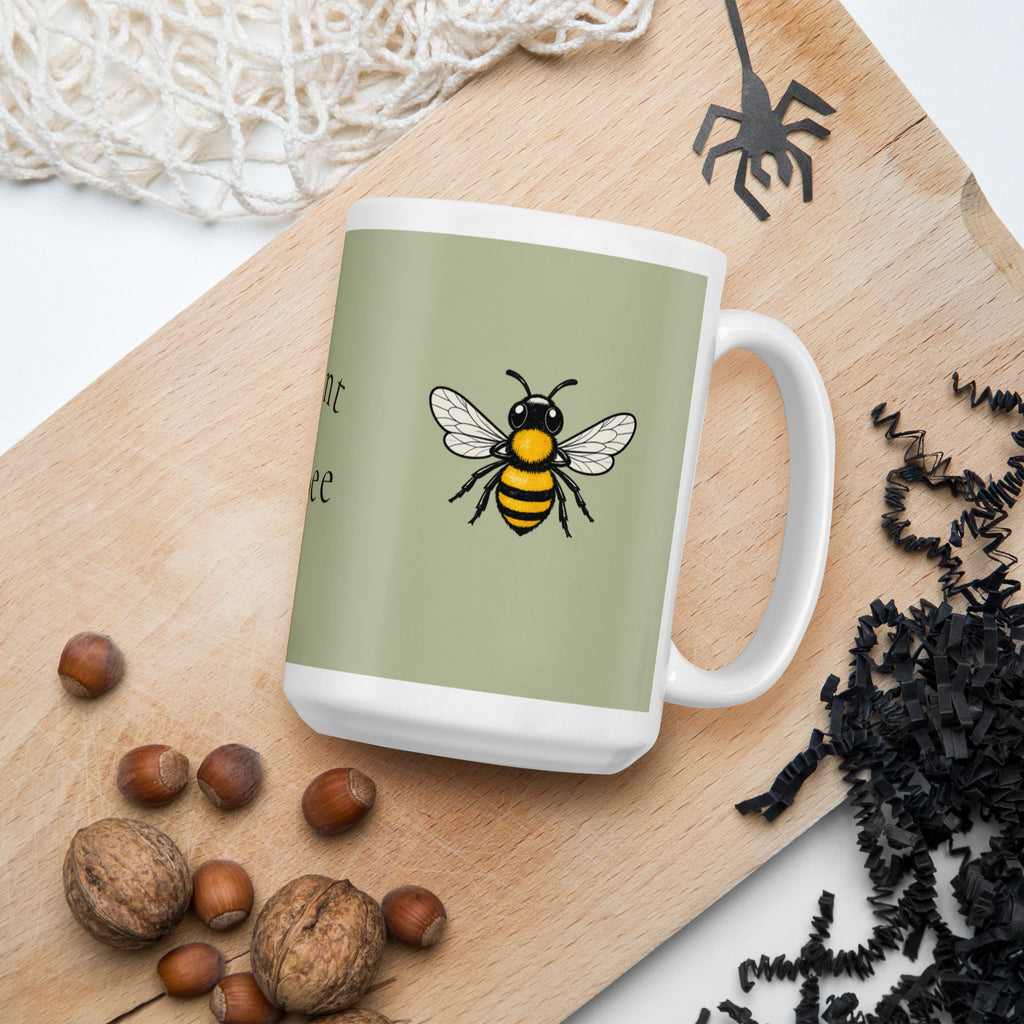 Sage green ceramic coffee mug with bee illustration and white handle, close-up