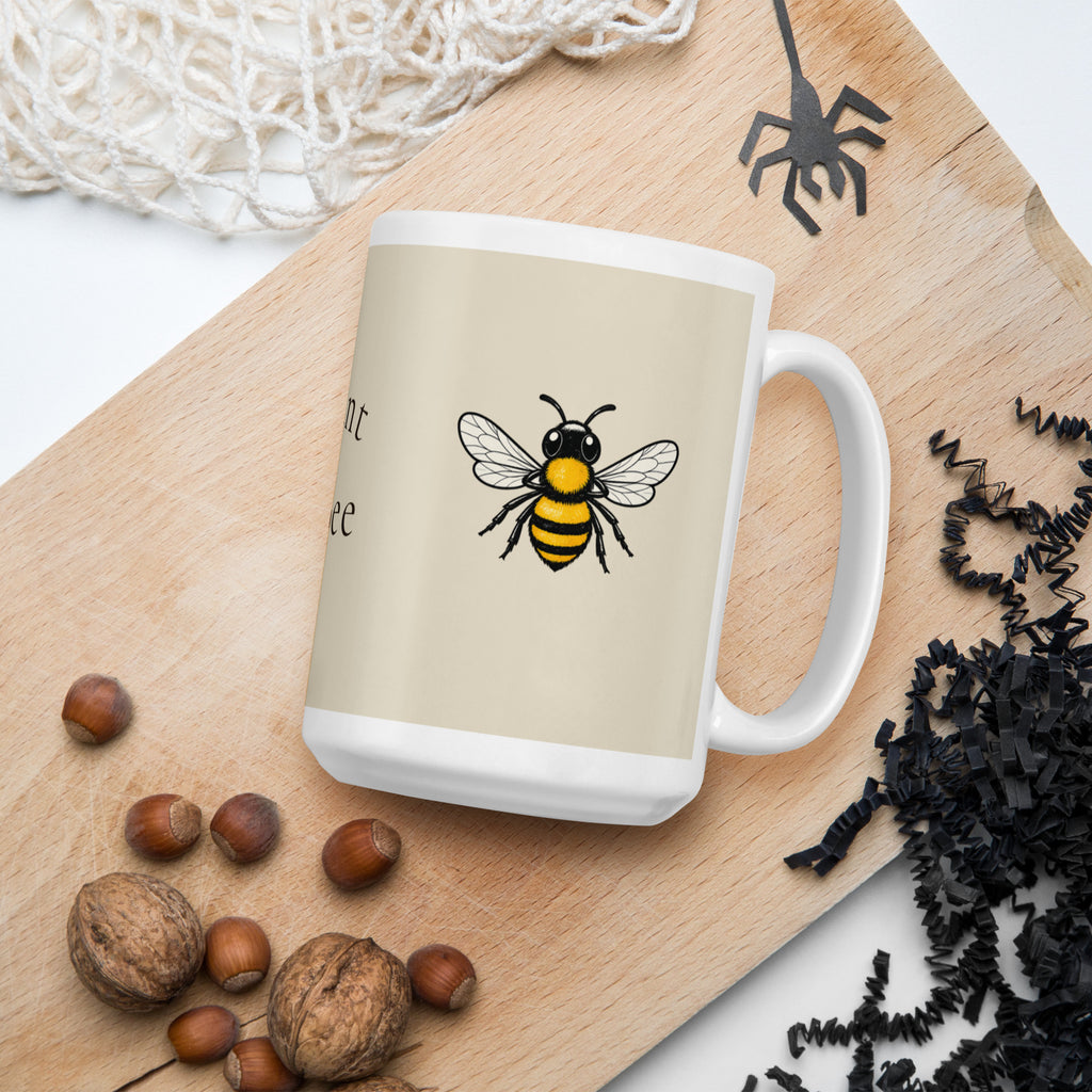 Light beige ceramic coffee mug with bee illustration on side, slightly angled