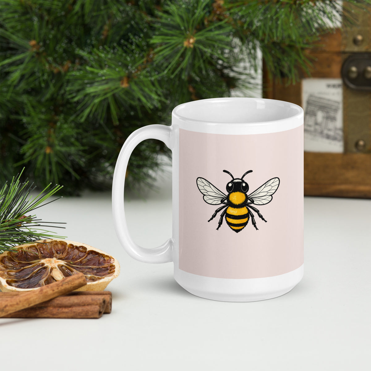 Ceramic coffee mug with centered bee illustration on pink panel, side angle