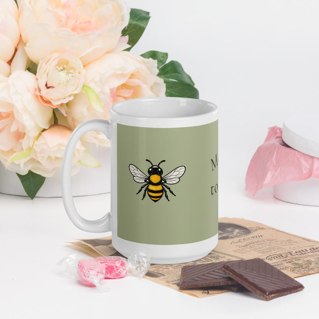Sage green ceramic coffee mug with white handle, bee illustration on front, side angle
