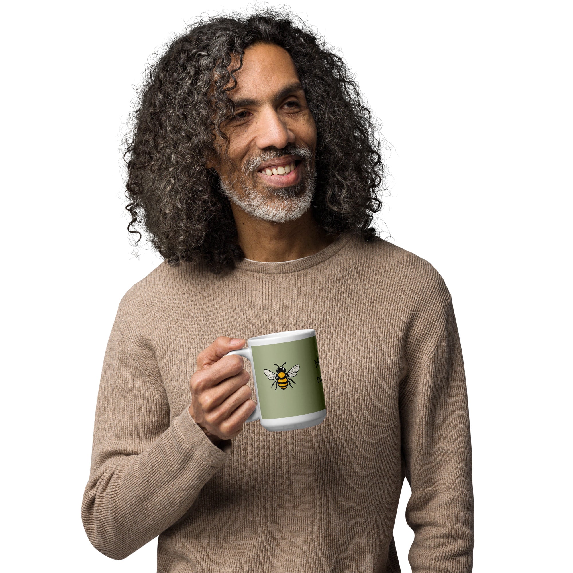 Sage green ceramic coffee mug with bee illustration, held in one hand