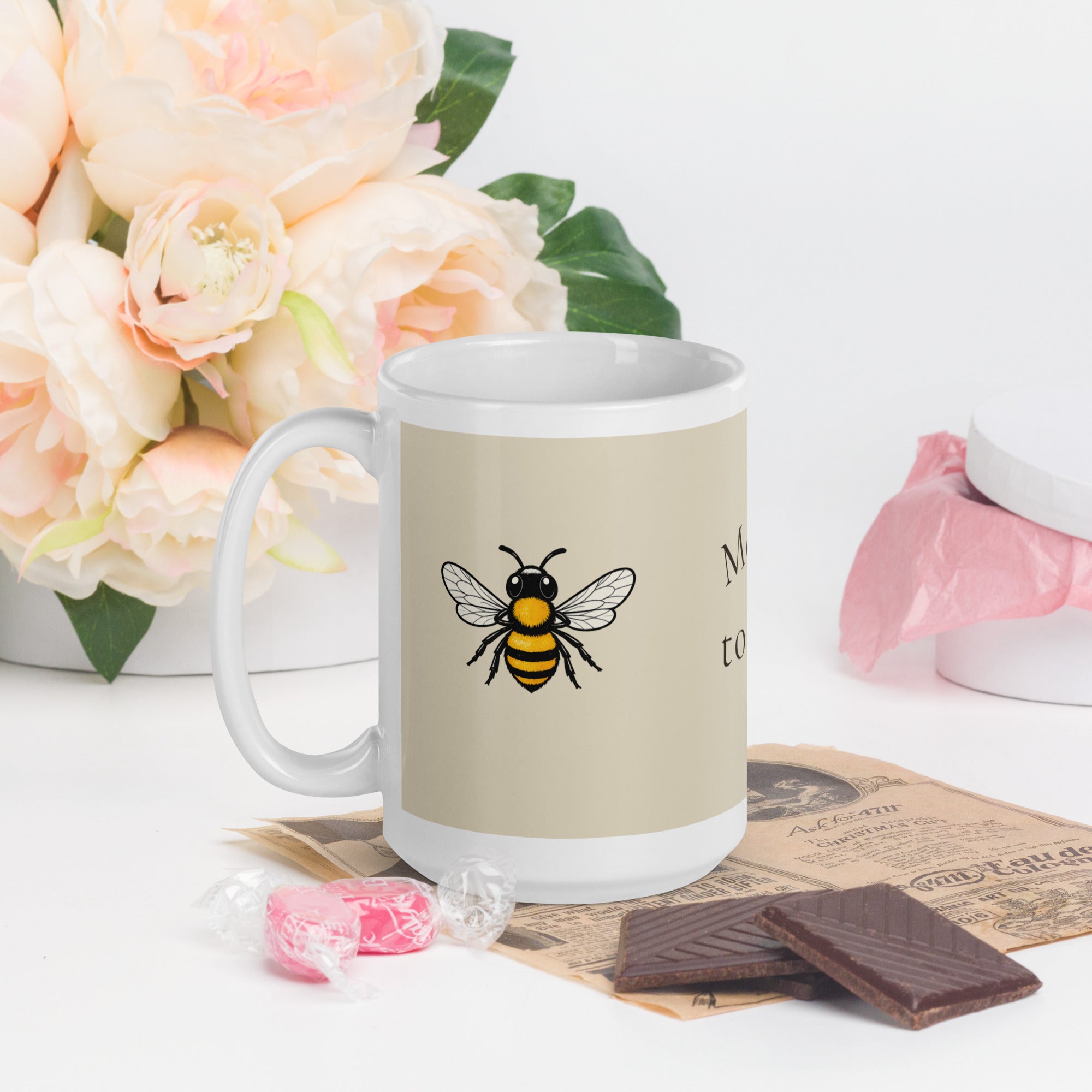 Light beige ceramic mug with bee illustration and white interior