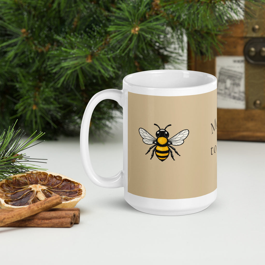 Beige ceramic coffee mug with bee illustration and white handle