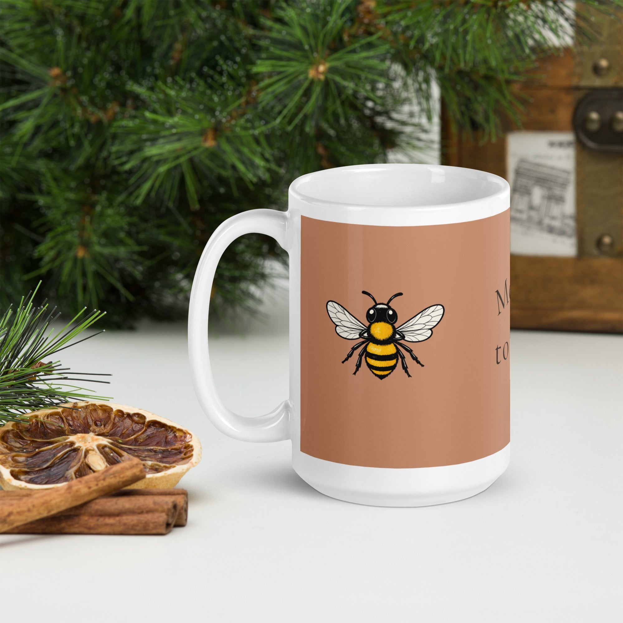 Brown ceramic coffee mug with white rim and bee illustration on the front