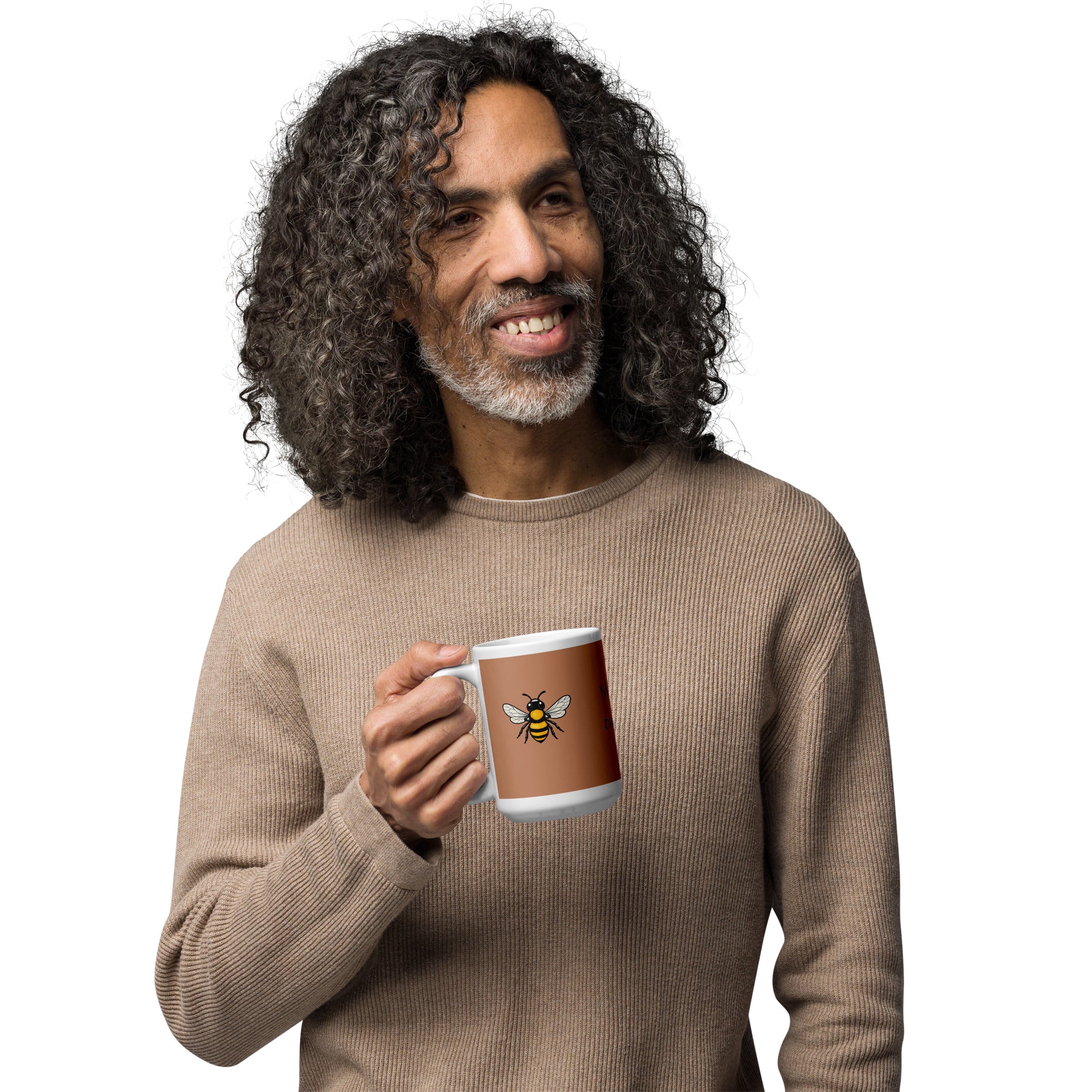 Brown ceramic mug with white rim and handle, yellow bee illustration; person holding mug