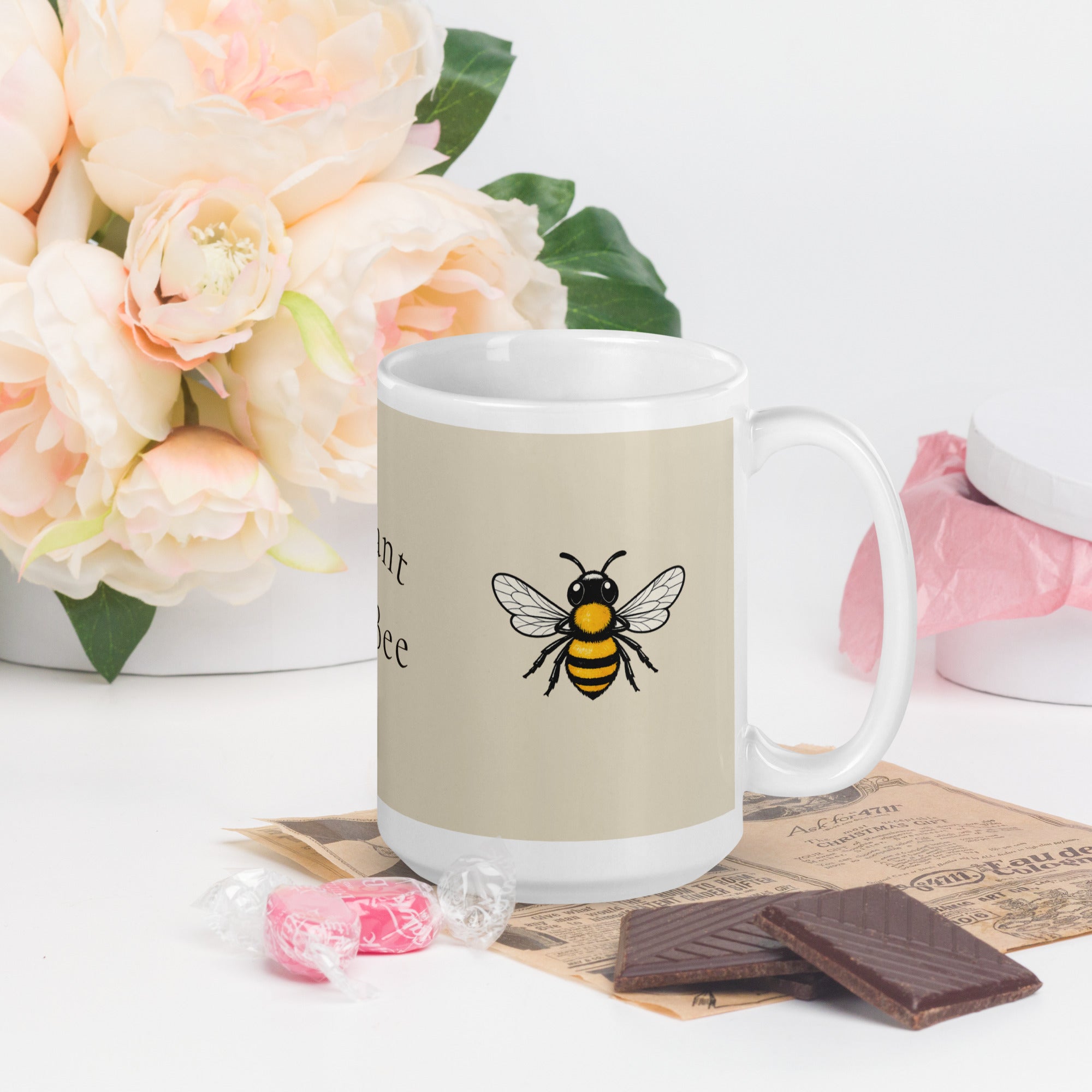 Light beige ceramic mug with centered bee graphic and white handle
