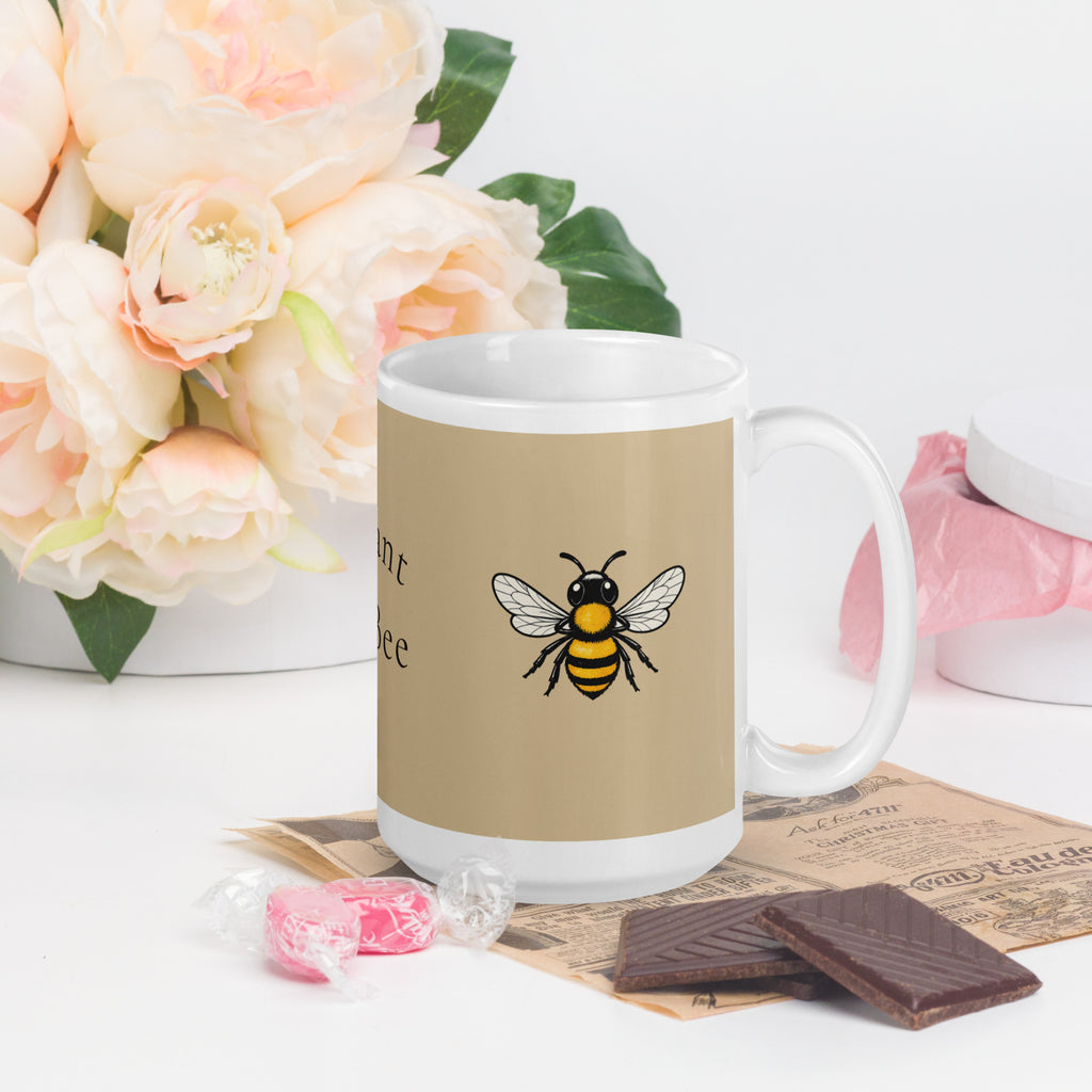 Beige ceramic coffee mug with bee illustration and white handle, front view