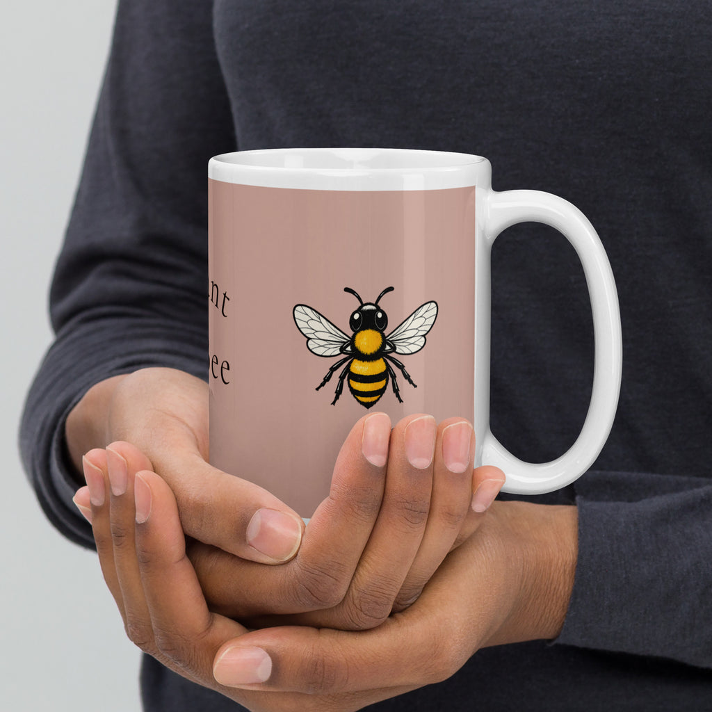 Dusty rose ceramic mug held in hands with bee illustration and white handle