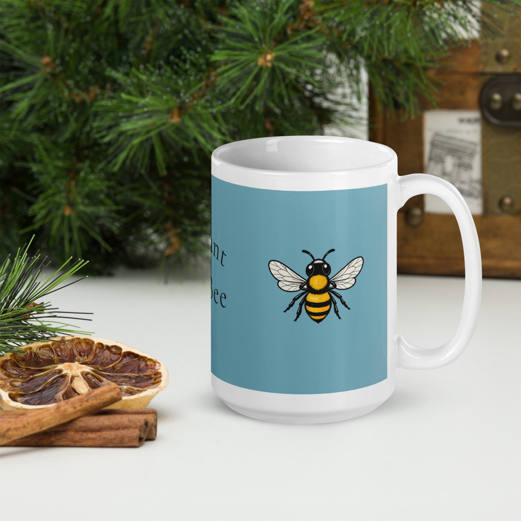 Blue ceramic mug with bee illustration on the front, slight side angle