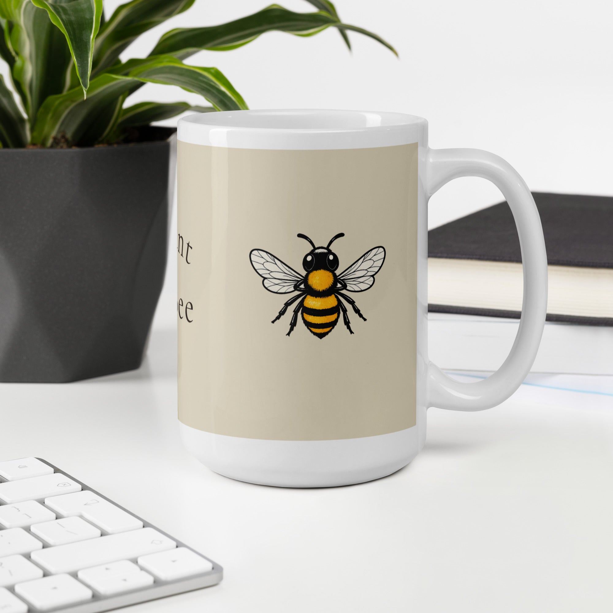 Light beige ceramic coffee mug with centered bee illustration and white handle
