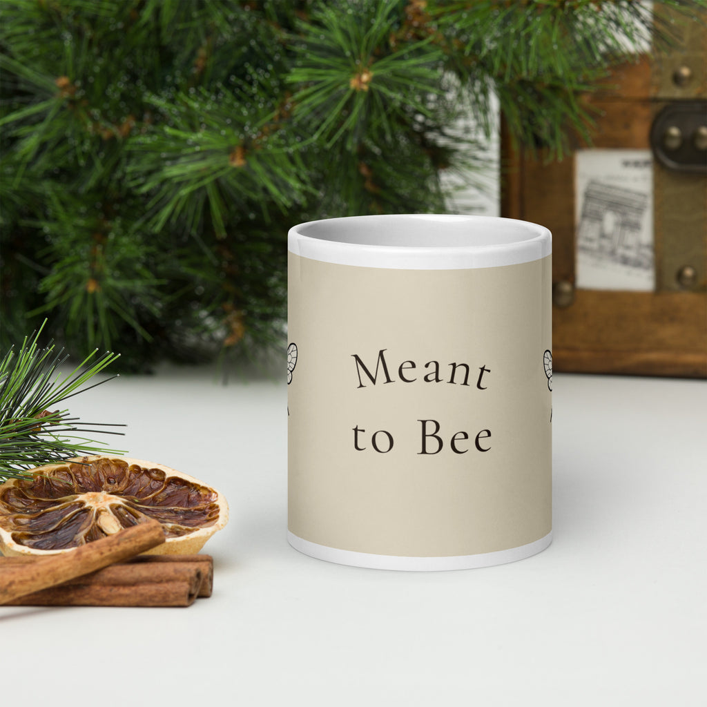 Light beige ceramic mug with 'Meant to Bee' text on front and white handle