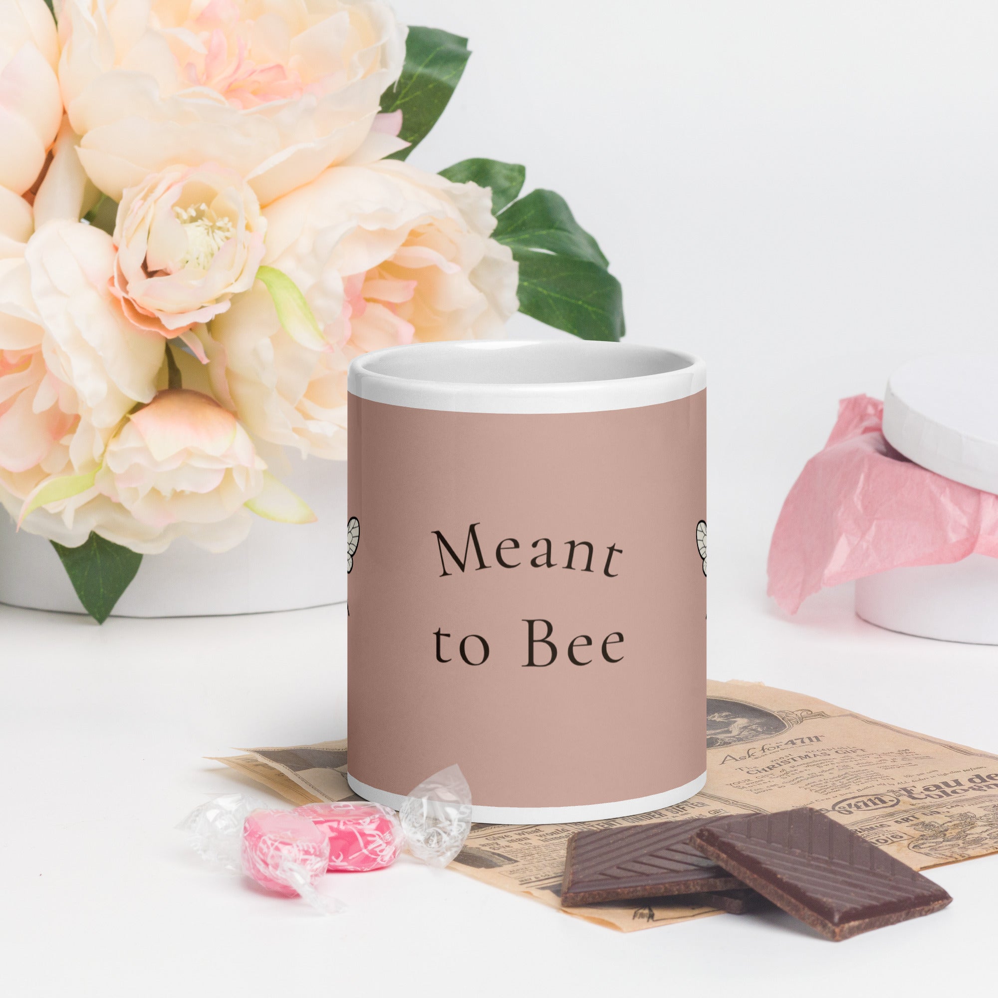Dusty rose ceramic mug with white rim and handle, 'Meant to Bee' text.