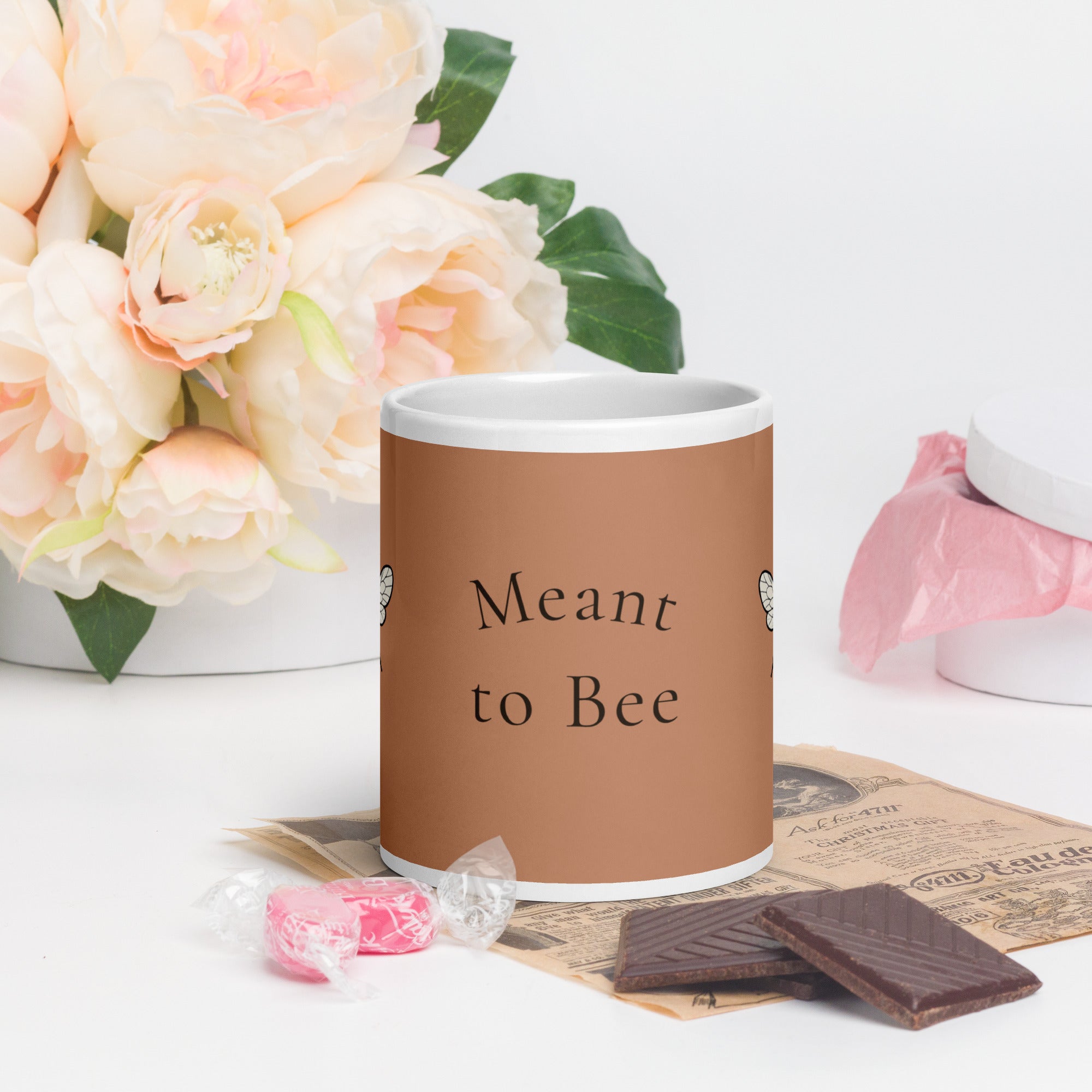 Brown ceramic mug with white rim, 'Meant to Bee' text and bee illustration