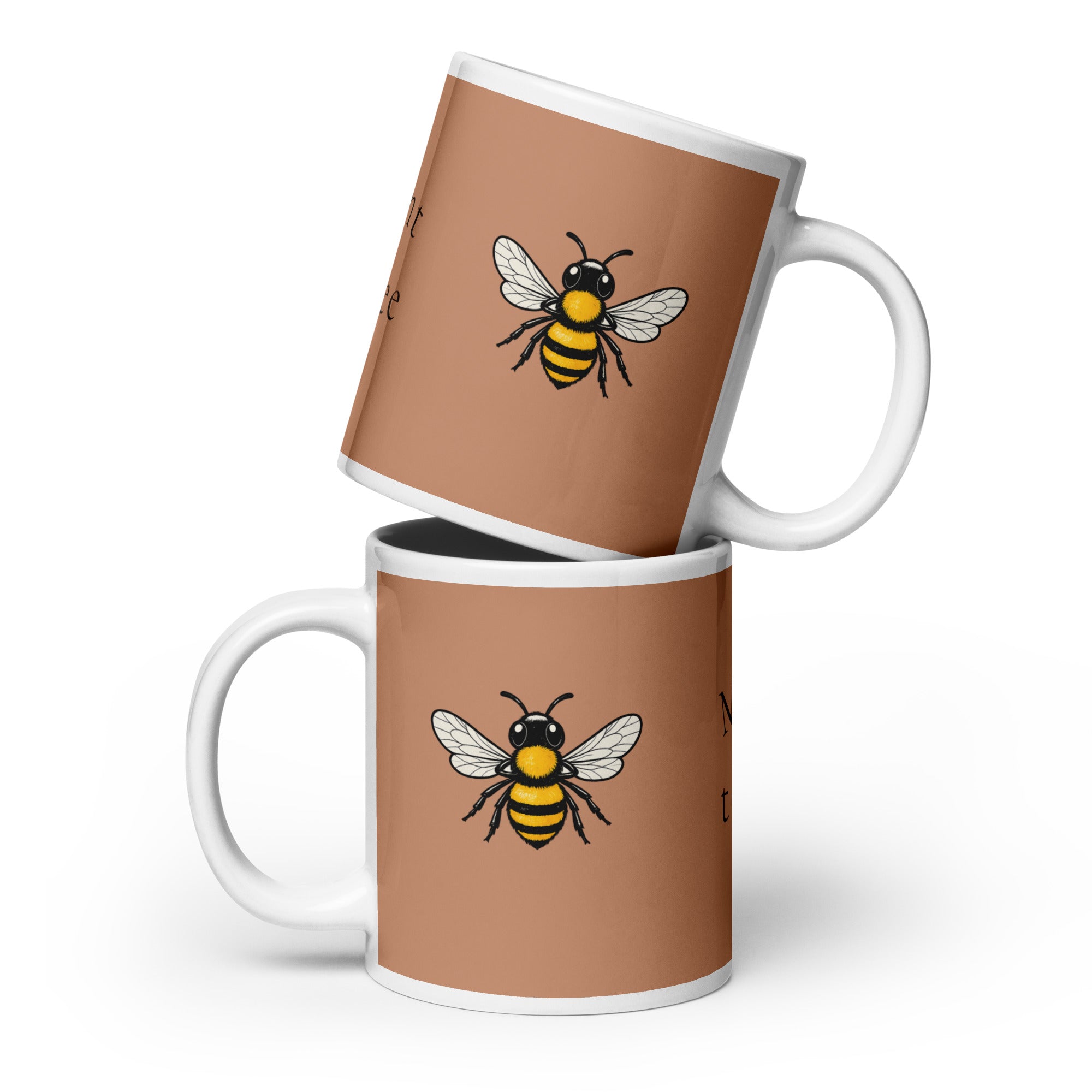 Stacked brown ceramic coffee mugs with bee illustrations and white handles