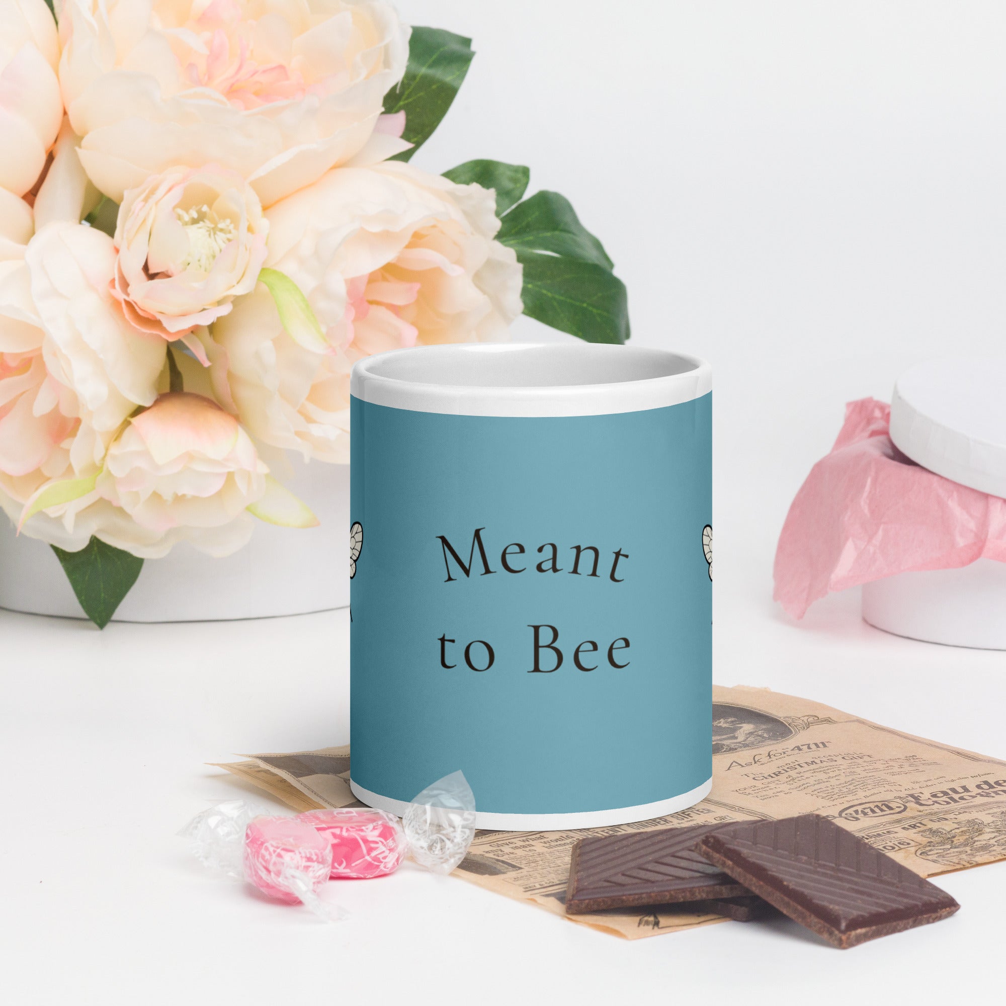 Blue ceramic coffee mug with “Meant to Bee” text and bee illustration