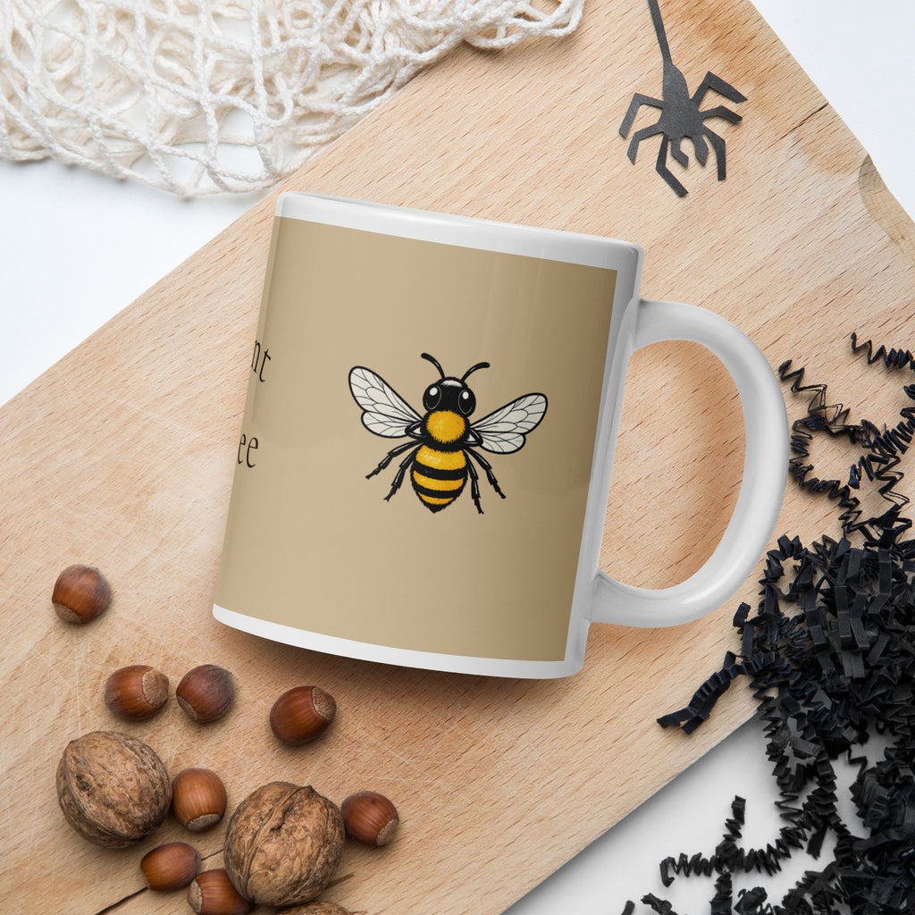 Beige ceramic mug with bee illustration on front, white handle